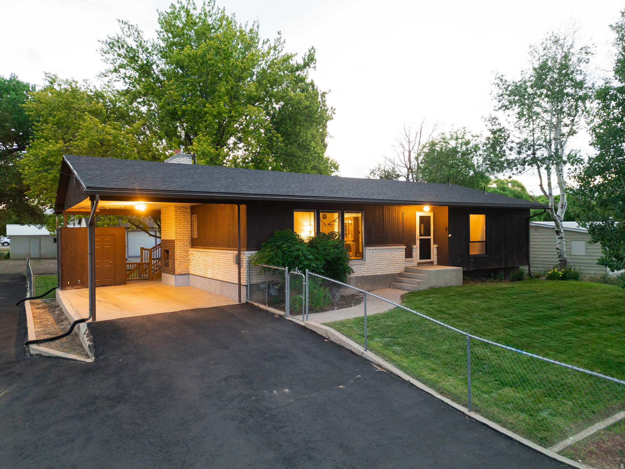Incredible .52 acre property with a huge shop.  4 Bedroom, 2 bath home with lots of elbow room.   So many new items in this home like a Roof, Windows, Furnace, AC, Water Heater, Microwave, Dishwasher, Stove and the Kitchen Sink.  The Blacktop in the drive was re-sealed in 2025.  There is a 30 X 40 Shop/Garage and an additional Shed.   This one also has an amazing circular staircase leading to the basement with a basement entrance as well.  Mature landscaping with plenty of shade surrounded by a chain link fence.  This home has been very well cared for and is move in ready.   Located at the edge of town but still close enough to all of the shopping and restaurants.  Square footage figures are provided as A courtesy estimate only and were obtained from the county records.  Buyers are advised to obtain an independent measurement.