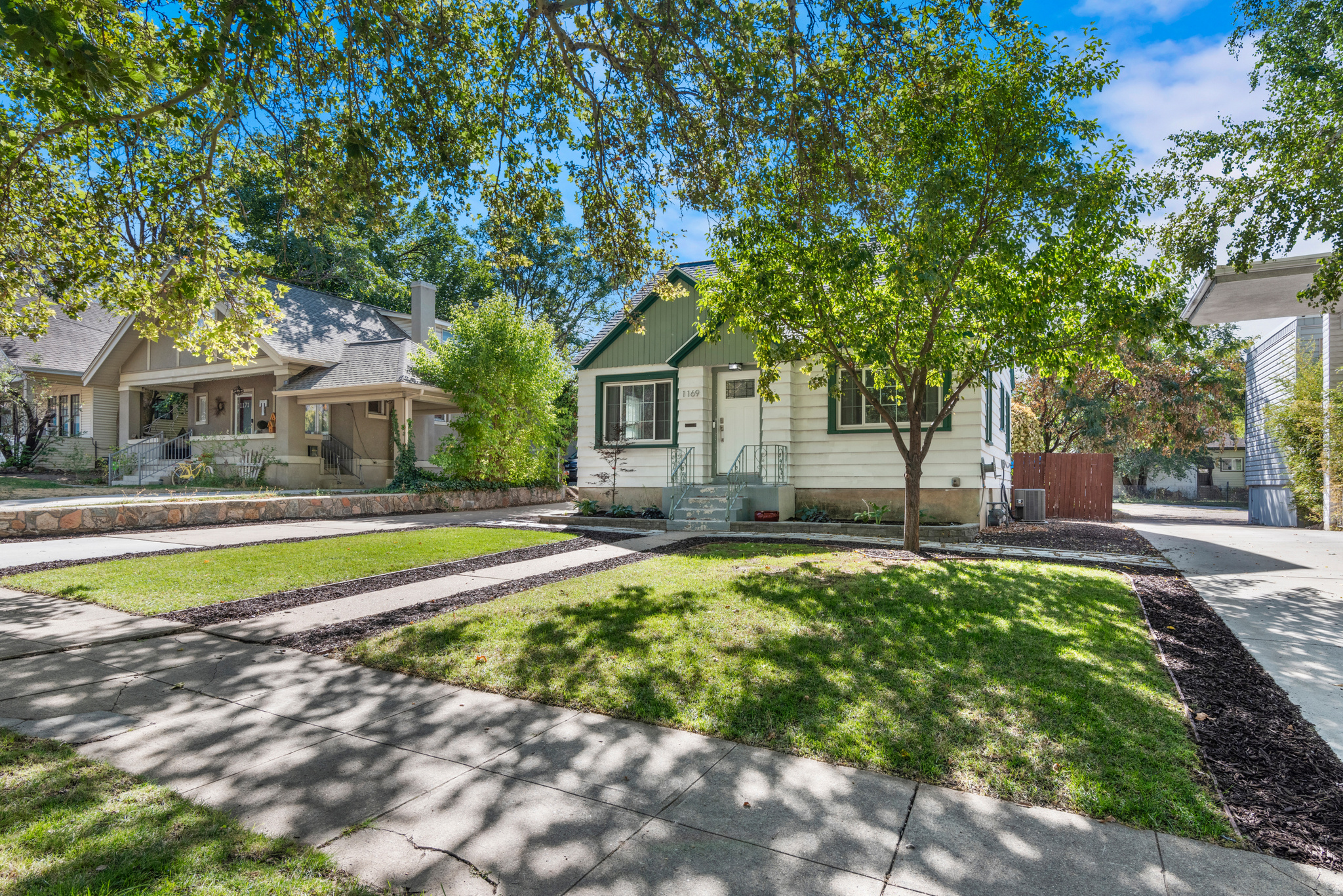 Tucked along one of Ogden's picturesque tree-lined streets, this darling 1940s cottage blends vintage character with thoughtful modern updates. Original hardwood floors, inviting living spaces, 4 bedrooms, and 2 recently remodeled bathrooms make the home feel both classic and functional. The updated kitchen features granite countertops, subway tile backsplash, and stainless-steel appliances, while major updates including electrical, main sewer line, newer AC, newer roof, and a fully redesigned sprinkler system add peace of mind. Outside, the fully fenced backyard offers a peaceful retreat with mature, water-wise landscaping, native plants, drip lines, and a covered patio perfect for relaxing or entertaining. A detached garage, carport, RV parking, and rear service-road access provide rare flexibility for parking and storage. Lovingly maintained and truly turn-key. All appliances included. Owner/Agent.