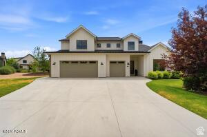 This Remund Farms Rockwell plan is nestled on an expansive lot with added privacy, an expanded patio and gas line. The oversized three car garage has expoxy floors and ample room for extra storage and toys. This Rockwell plan was re-designed for optimal comfort and utility.l Upstairs you will find three large ensuite bedrooms along with a large walk-in storage area and a cozy family/TV room for the kiddos. The main level welcomes you with a bright glass entry door, luxury LVP flooring, a sundrenched great room with 14 ft ceilings and added windows that look out to the community path and the mountains beyond. There is  a secondary storage room with sink and cabinets, plus a 3/4 bath and fifth bedroom/study. The gourmet kitchen is accented by  a wall of windows and features a marble center island and walk in pantry. The main level primary has a cozy fireplace, soaking tub, double sinks and a separate tub/shower. Remund Farms is the most sought after community in Midway. Amenities include a clubhouse, workout room, outdoor pool, playground, pickleball courts and beautifully landscaped grounds and walking paths.  Ideally located in the heart of historic Midway. this community allows for  easy bike rides or leisurely walks to Midway's main street with quaint shops and excellent dining. Owners may consider some financing.