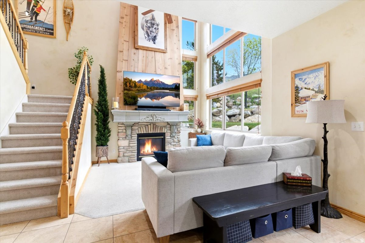 Nestled at the base of Powder Mountain Ski Resort, this well cared for Classic luxury styled modern townhome offers the ultimate four-season mountain lifestyle. Ideally located within a 20-minutes of Snowbasin Ski Resort and even closer to Nordic Valley Ski Resort, outdoor recreation is always within reach. Enjoy living adjacent to the 2nd fairway of Wolf Creek Golf Course, quick access to hiking and biking trails, plus nearby boating, paddleboarding, and water recreation at Pineview Reservoir. The HOA permits short-term rentals, making this an exceptional primary residence, vacation getaway, or investment opportunity.  Inside, the spacious floor plan comfortably accommodates guests, get togethers and features a large movie theater room perfect for entertaining.  Many recent updates including, kitchen and bathroom, custom cedar fireplace riser, custom copper stove vent/hood, kitchenette in the basement, and color selectable lighting throughout among many others. A 2-car garage with a professionally installed epoxy floor and heavy duty ceiling storage racks, offers ample storage for all your mountain gear and storage needs.  A lock-out sweet on the upstairs level with a separate entrance provides creative flexibility to suit almost anyone's needs.  A quiet and secluded backyard with a large patio,  hammock spots and mountain views completes this property for almost any Buyer!