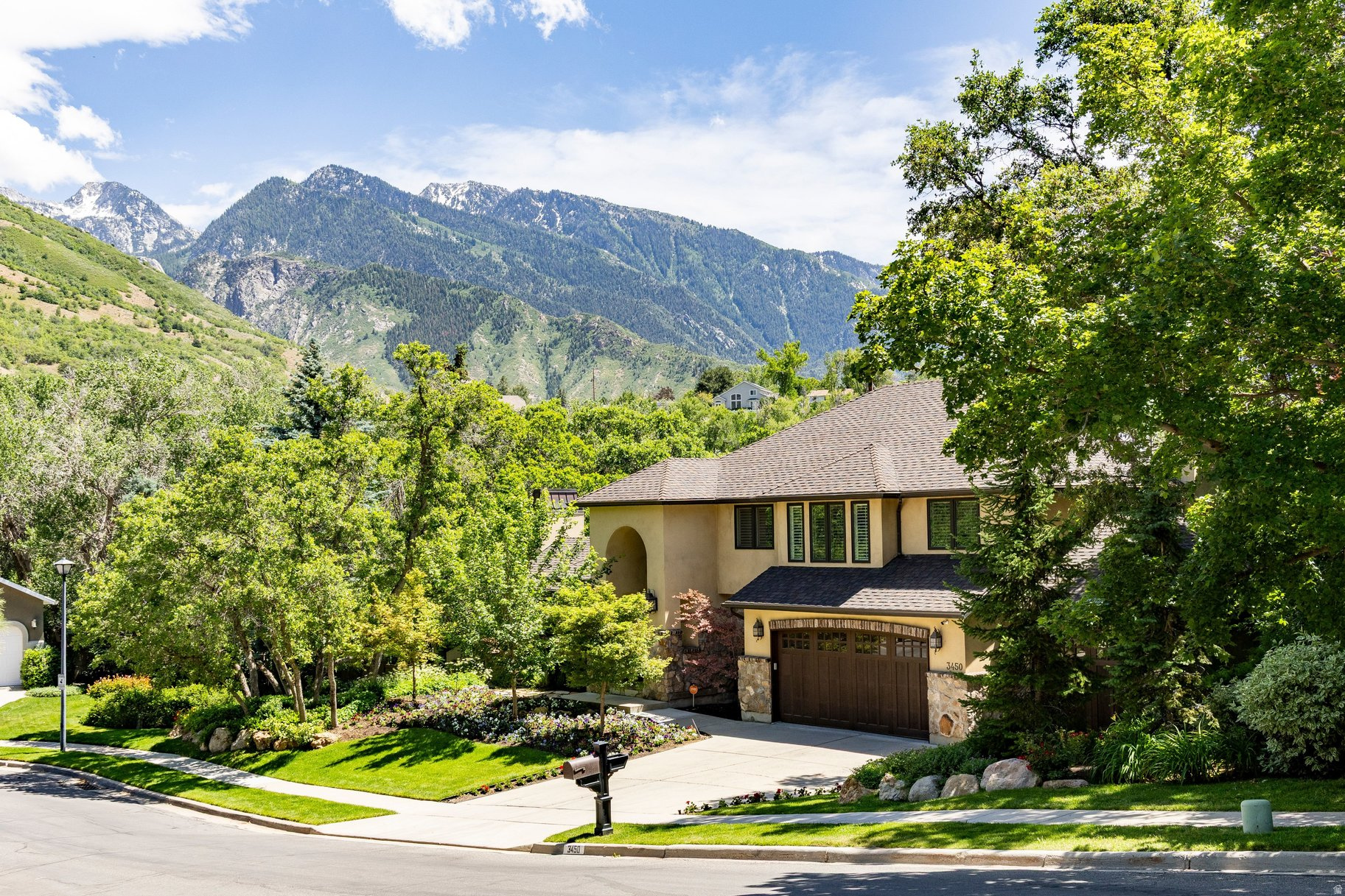 Nestled in the coveted Upper East Bench of Cottonwood Heights, this exceptional luxury residence offers over 5,200 square feet of refined living space on a private .49 acre lot with breathtaking mountain views. Featuring six bedrooms, 3.5 bathrooms, and a three-car garage, this beautifully updated home combines timeless craftsmanship, modern luxury, and an unparalleled outdoor lifestyle in one of Utah's most sought-after locations. A dramatic entry welcomes you into elegant formal living and dining spaces, a private office, all enhanced by a soaring vaulted beamed ceiling, abundant natural light, and a striking fireplace accented by a hand-carved mantel. Every detail throughout the home reflects enduring quality, thoughtful design, and a meticulous attention to detail. A newly renovated chef's kitchen designed for both entertaining and daily living is joined by a comfortable family room space, perfect combo for family get togethers. The line up in the kitchen includes Sub Zero refrigerator and freezer, Wolf appliances, six burner range, four ovens, warming drawer, microwave, and the ever popular pebble ice machine. The luxurious primary suite serves as a private retreat, featuring a delightful renovation with heated bathroom floors, steam shower, deep soaking tub and two oversized walk-in closets. Step outside to an extraordinary backyard designed for year-round enjoyment. Mature landscaping and towering trees create remarkable privacy while a resort-style swimming pool, waterfall feature, pizza oven, gas fireplace, trampoline, play set, swing, slide provide endless opportunities for relaxation and entertaining. Additional highlights include newer Pella efficient windows, plantation shutters, high efficient HVAC system, two year old 90 gallon water heater, and a 22-kilowatt propane powered back-up generator. The lowest level of the house provides walkout access to the amazing backyard for additional flexibility for family living. Located just minutes from Big and Little Cottonwood Canyons, you will enjoy immediate access to world-class skiing, hiking, biking, golf, and outdoor adventures. Shopping and dining are close and the Salt Lake International Airport is just 25 minutes away. A rare opportunity exists to purchase this property separately or together with the adjacent 3,300 ft. Luxury casita residence, creating an extraordinary multigenerational family compound. The detached residence offers a main-level primary suite, four bedrooms, 3.5 bathrooms, a two car garage and a creek that runs along the back of the house. This is an exceptionally uncommon offering in today's market.