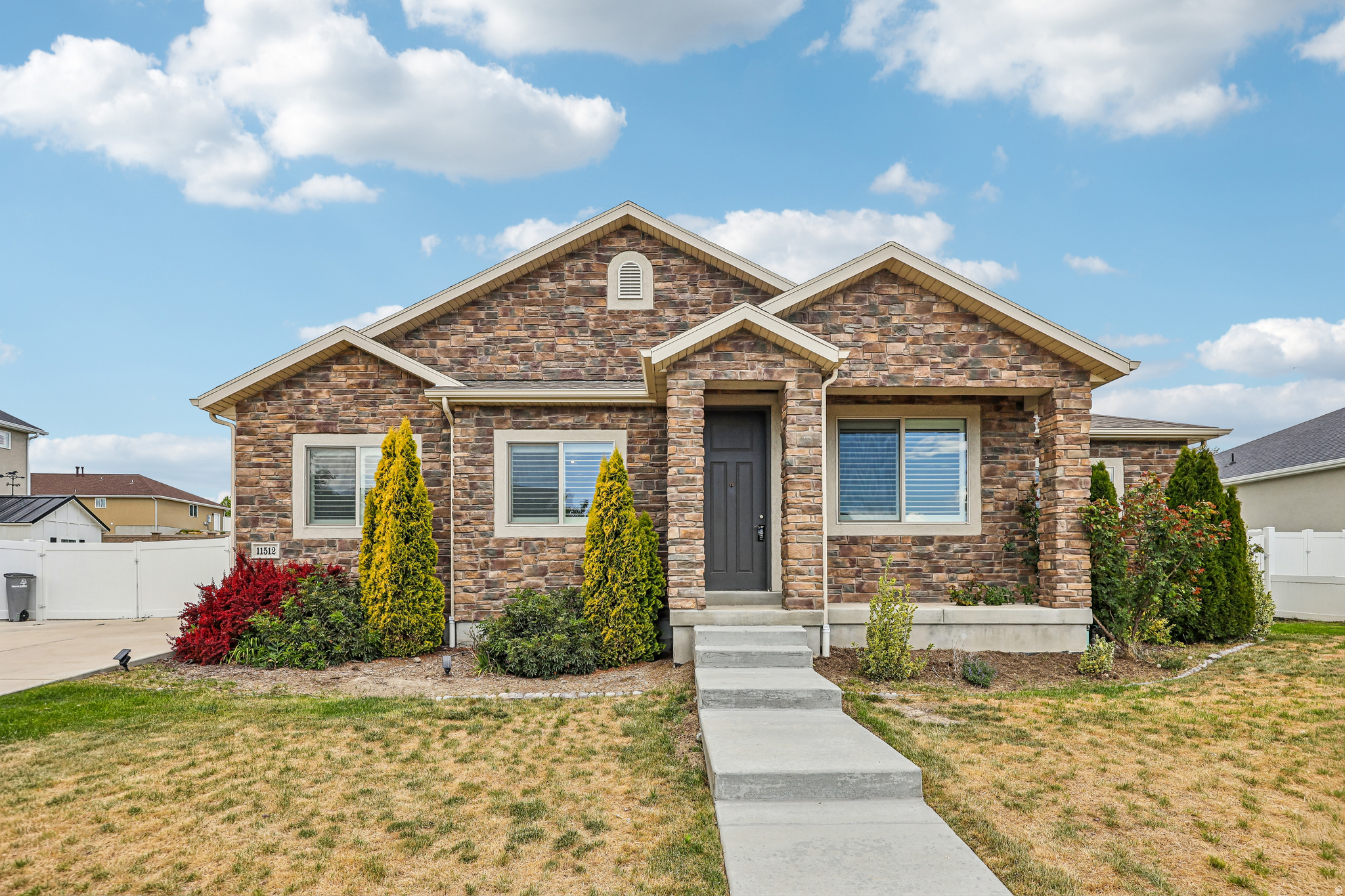 Welcome to 11512 S 4135 W, a home that exudes charm and sophistication. The kitchen is a chef's dream with an accent backsplash, all stainless steel appliances, and a functional kitchen island. The living room is cozy and inviting with a beautiful fireplace. The primary bathroom is a oasis featuring a separate tub and shower. The primary bedroom boasts a spacious walk-in closet. Outside, you'll find a covered patio perfect for entertaining and a fenced-in backyard for secure. This home is a perfect blend of style and comfort. Included 100-Day Home Warranty with buyer activation