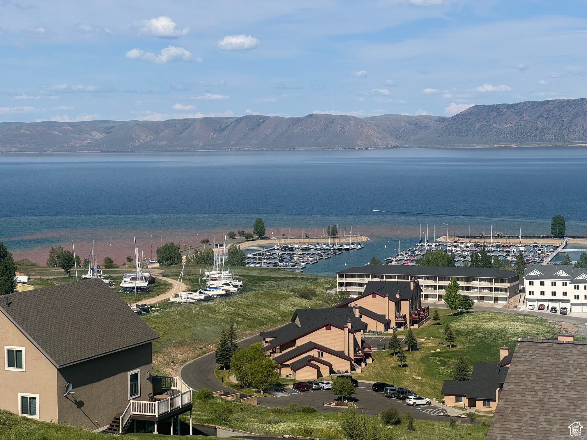 Incredible lake and marina views from this updated tri-level townhome located across from Bear Lake State Park Marina. 2 bedrooms, 3 baths with a lower entertainment area with a fireplace, wet bar, and game room.  Also has 3 roll away twin beds. Two decks plus a patio--Lakeviews from every level. Paved roads, year round access, close to downtown for shops and dining, paved bike/walking path.  Short term rentals allowed. Sold furnished.