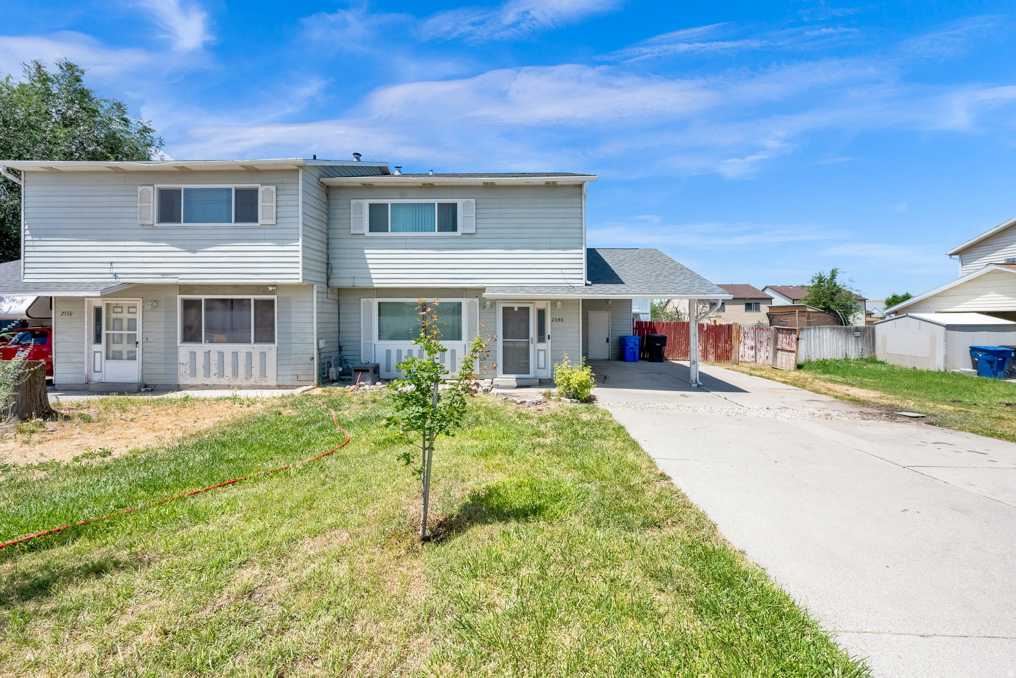 This charming 2-story twin home is perfect for a first-time homebuyer or anyone looking to downsize without sacrificing comfort. Enjoy the peace of mind that comes with numerous updates, including a new roof (2026), double-pane windows (2024), A/C condenser (2021), furnace (2019), Pelican no-salt water softener (2019), and a beautifully updated upstairs bathroom (2025). Step outside to a fully fenced backyard designed for relaxing and entertaining, featuring a spacious patio with an oversized awning, firepit, garden area, mature trees, and a large two-story storage shed. Conveniently located with quick access to SR-201, Bangerter Highway, and the freeway, this home is just minutes from shopping, restaurants, schools, and everyday amenities. Agent related to Seller.