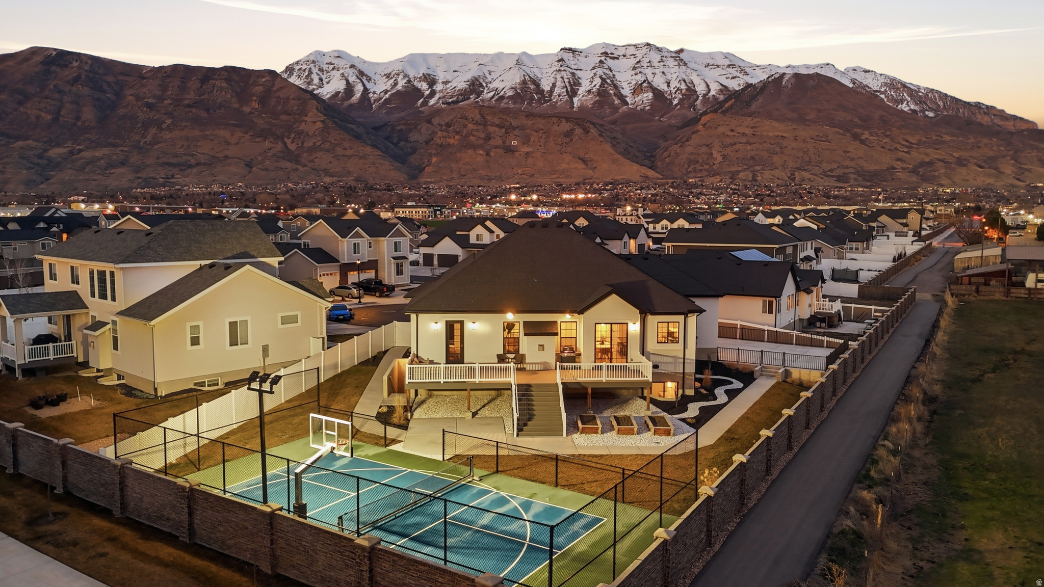NEW PRICE: $1,249,000! Private pickleball court, second living suite, and no rear neighbors! This beautifully upgraded 2022 Lindon rambler offers vaulted ceilings, an open great room, quartz countertops, Monogram appliances, a walk-in pantry, and main-level laundry. The main floor includes three bedrooms and 2.5 bathrooms, including a luxurious primary suite with deck access, a spa-style shower, and a custom closet. The walkout basement features 10-foot ceilings, a private entrance, full kitchen, laundry, two bedrooms, one bathroom, cold storage, and flexible spaces for entertaining, working, or exercising. Enjoy mountain views, low-maintenance landscaping, an illuminated pickleball and basketball court, a three-car garage, and a quiet cul-de-sac location. With exceptional amenities and versatile living space, this home truly stands apart. Schedule your private showing today! Buyer to verify all listing information, including square footage.