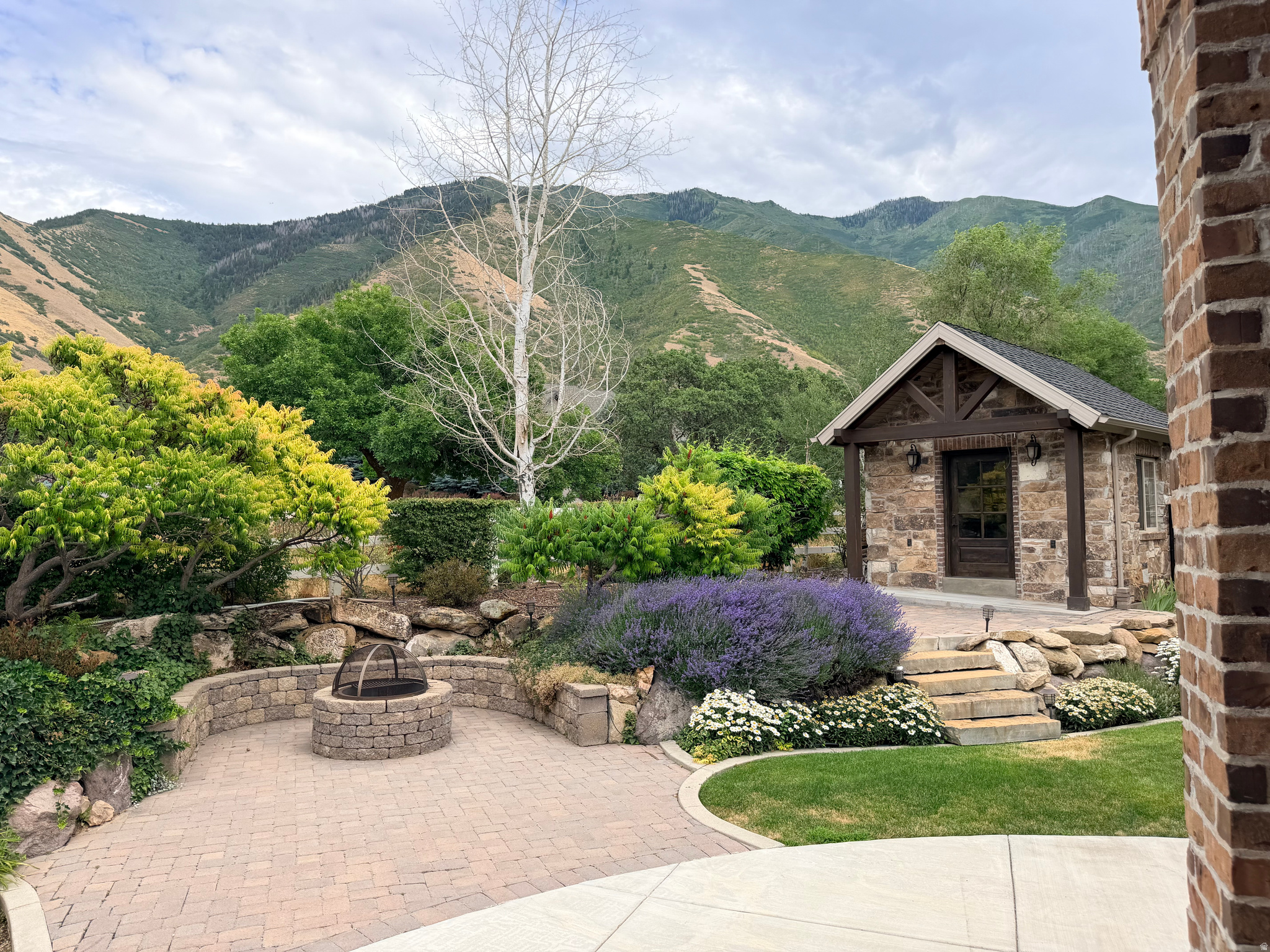 Nestled in the heart of highly desirable Mapleton, this exceptional home offers the perfect blend of luxury, comfort, and breathtaking scenery. Surrounded by stunning mountain views and backing directly to a peaceful walking trail, you'll enjoy privacy, convenience, and the beauty of Utah living right outside your door. The meticulously maintained yard creates incredible curb appeal and provides the perfect setting for relaxing evenings, entertaining guests, or simply enjoying the surrounding landscape. Inside, soaring vaulted ceilings and an open, inviting floor plan fill the home with natural light while creating an elegant yet comfortable atmosphere. Designed with flexibility in mind, this home offers the convenience of single-level living with everything you need on the main floor. The fully finished walk-out basement features a second kitchen, making it an ideal setup for multigenerational living, extended family, guests, or entertaining. Every detail has been thoughtfully designed to provide luxury, functionality, and timeless appeal. Whether you're captivated by the spectacular mountain views, the beautifully landscaped grounds, or the versatile floor plan, this Mapleton gem is a rare opportunity to own a home that truly has it all.