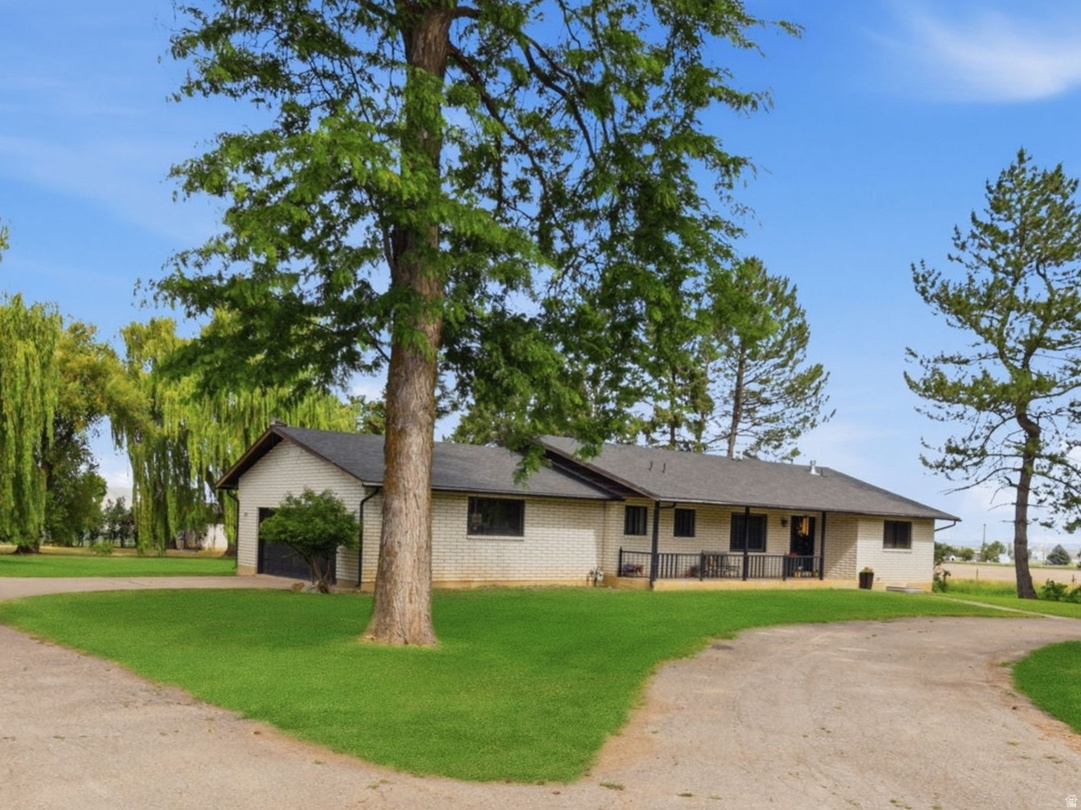 Experience the perfect blend of country living and modern comfort on this exceptional 7+ acre Cache Valley horse property. Designed with both equestrian enthusiasts and hobby farmers in mind, this fully fenced property features four separate pastures, a 5-stall horse barn, tack shed, spacious Quonset, frost-free hydrants, irrigation pipe, and 7.5 water shares. Productive hay ground, irrigated pasture, a pond for irrigation, mature fruit trees, and beautiful established trees make this a truly functional and picturesque property. The impressive shop with a vehicle lift offers endless possibilities for projects, equipment, hobbies, or additional storage. Inside, you'll find an updated home designed for comfortable main-floor living, including a spacious primary suite. Fresh new carpet throughout, an open-concept kitchen with a stunning oversized island and double ovens, and inviting living spaces make this home perfect for both everyday living and entertaining. Whether you're looking for a turnkey horse property, a productive small farm, or simply room to enjoy the beauty of country living, this rare offering combines exceptional acreage, outstanding amenities, and an updated home in one of Cache Valley's most desirable settings. Square footage figures are provided as a courtesy estimate only and were obtained from county records .  Buyer is advised to obtain an independent measurement.