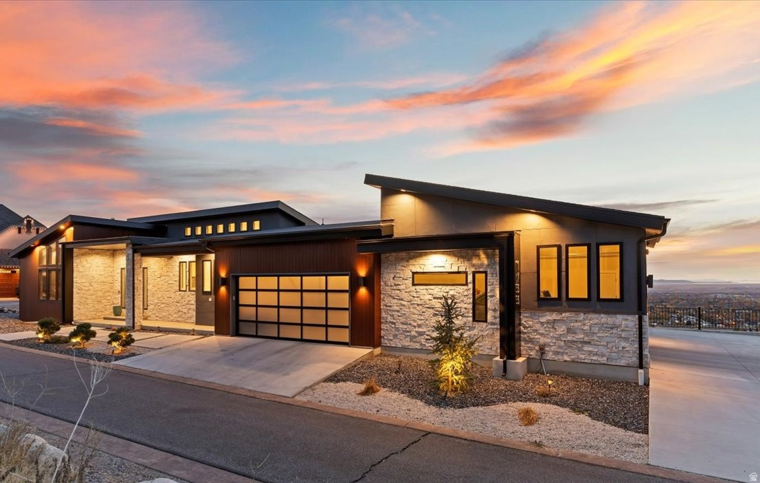 Private, Peaceful, Perfect in this distinctive custom built home in the Deer Crest at Hidden Springs Gated Community featuring handsome exterior of wood-look metal, stone and stucco, and unlimited views of the Great Salt Lake, valley and mountains! Thoughtfully designed home with single level living in mind, the interior indulges you with the expansive great room with electric fireplace with stone surround, 20' vaulted ceilings, beautiful tile flooring, upgraded lighting and ceiling fans, remote control window shades, dramatic kitchen with dark stained cabinets / double ovens / desirable 6-burner gas range with griddle / SS vent hood / tile backsplash / side-by-side refrigerator / center island with pendant lighting, plus additional refrigerator in the large walk-in butlers pantry, large open dining area. Double sliding glass doors lead to the full length epoxy coated covered deck with outdoor kitchen, romantic views, glass railings, fireplace and spiral staircase leading to lower patio. Primary bedroom with en-suite having marble floors, free standing soaking tub, marble shower, huge walk-in closet. Split floor plan with guest bedroom with walk-in closet and 3/4 bath. Laundry/mudroom complete the main level. Suspended staircase with glass railings lead to the lower level featuring generous family room, 2 bedrooms and 1 full bath plus additional laundry room. Lots of potential for the 1,104 sq ft under the suspended garage! Full length lower level covered patio too! Extensive 4- car garage, wired for 220, with glass garage doors. Home has $25,000 fire suppression system plus 19 caisson piers were installed for earthquake proofing costing $240,000. The Hidden Springs community enhances your lifestyle with a clubhouse having a full kitchen, pool and hot tub, workout facility, and walking trails, all within close proximity to high-rated schools, Station Park Shopping Center, parks, and outdoor activities. Plus, with easy access to freeways and just 20 minutes to ski resorts and Salt Lake International Airport, convenience is at your fingertips. Owner/agent. Schedule via Aligned Showings.