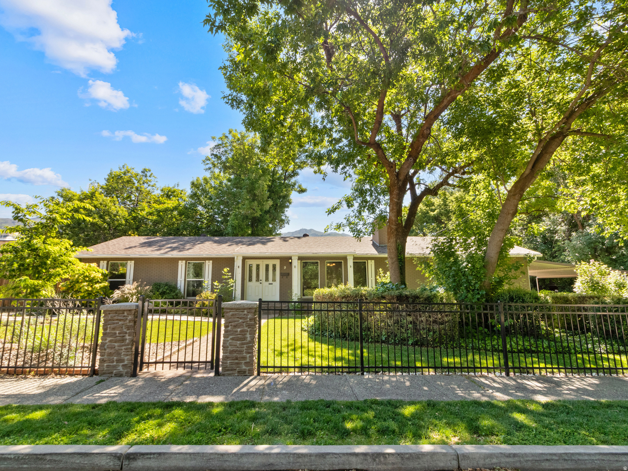 Located in the heart of historic Kaysville, this beautifully maintained single-level home offers the perfect blend of comfort and convenience. Enjoy a walkable neighborhood just minutes from local shops, dining, parks, and everyday amenities. The professionally landscaped and fully fenced yard features mature trees, a relaxing Dimension One hot tub, and no backyard neighbors. Inside, you'll find true hardwood flooring throughout, an upgraded gourmet kitchen with granite countertops, and an inviting layout designed for easy living. The oversized and heated garage provides ample space for parking, storage, hobbies, and more. Enjoy the additional covered driveway, RV parking, storage shed and greenhouse. Take advantage of the ease of single-level living in a location that perfectly balances neighborhood charm with everyday convenience.
