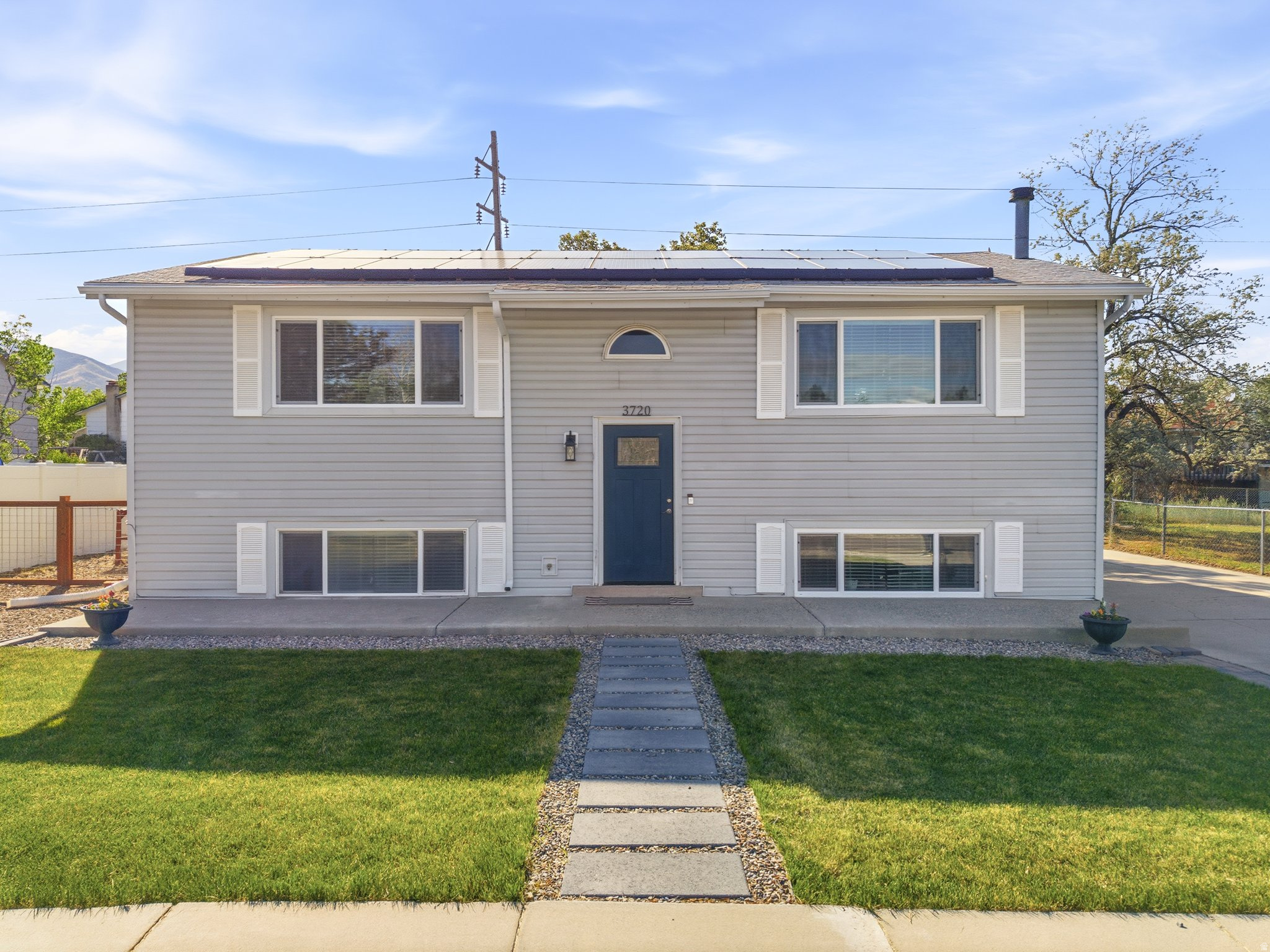 This charming home tucked away in a quiet Magna neighborhood is conveniently located within walking distance to designated schools, including a short walk to Copper Hills Elementary and Matheson Jr. High, as well as just a 1015 minute walk to Magna Regional Park. This well-maintained property offers thoughtful updates, flexible living space, and incredible added value throughout. The impressive main kitchen features shaker-style cabinetry, stainless steel appliances, recessed lighting, a large island, and a beautiful farmhouse sink. You'll also enjoy double-pane windows, spacious bedrooms, and a basement walkout with a legal ADU apartment complete with a separate entrance and basement kitchen - perfect for rental income, multigenerational living, or guests. Additional highlights include Vivint Solar panels for lower energy bills (lease transfer required), Google Fiber availability, tons of off-street parking, and all appliances included. The chicken coop and chickens can stay if desired, and the play set is also included. Over the last four years, numerous improvements and additions have been made, including a basement kitchen, new water heater (2025), water softener, three new windows replaced in 2026, new gutters, updated bathroom vanities and fixtures, farmhouse kitchen sink and fixtures, new front door, exterior lighting, custom living room built-in cabinet, shed, garden beds, peach tree, thornless blackberry plants, play set, and chicken coop. This home combines comfort, functionality, and outdoor charm with room to grow and enjoy.