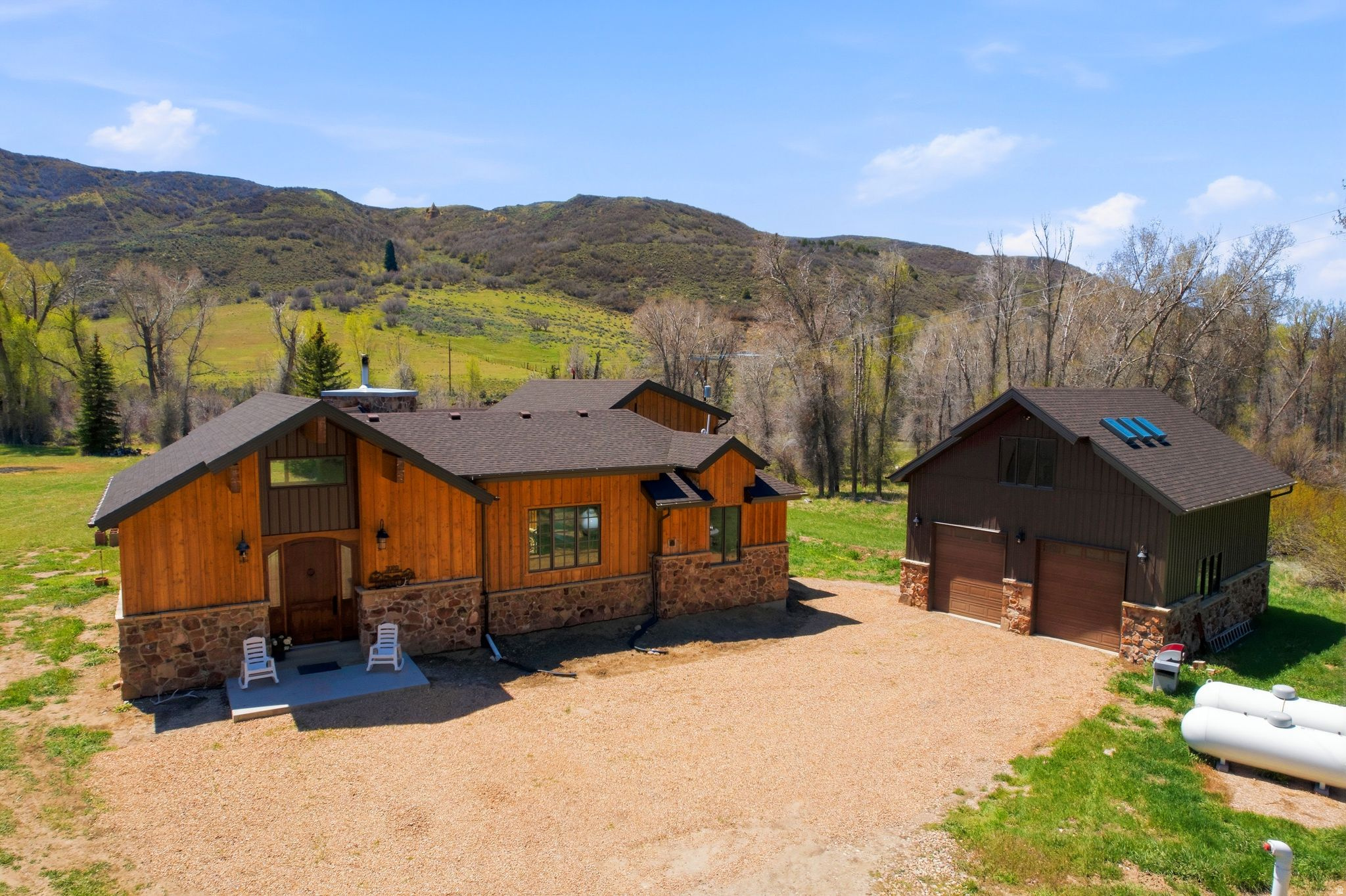 Proudly presenting a rare opportunity of year round accessible riverfront living in Summit County. 3020 E Chalk Creek Rd. boasts deeded acreage on both sides of Chalk Creek, a fantastic trout fishery that sees very little pressure due to it being predominantly privately owned with little to no public access. This 3 acre oasis is very flat and suitable for equestrian pursuits, with a round pen already established. Chalk Creek is an outdoor lover's paradise with stunning views in every direction including towards the nearly 11,000 foot Humpy Peak. The property is situated within a major Elk and Deer migration corridor making these Cervidae's not difficult to admire. In addition to the stunning natural setting a beautiful 3,481 square foot, 4 bed 2.5 bath 2019 built home with a massive oversized 3 car detached shop, featuring unfinished space above, is ready to serve as your family gathering place, private fishing retreat, or full time residence where you can unwind at the end of the day with a fly rod in your hand. Located 15 minutes from Coalville, 40 minutes from Park City, and 1 hour from the Salt Lake International Airport, this opportunity not only allows for a unique mountain, riverfront experience, but an added level of convenience and accessibility with its proximity.