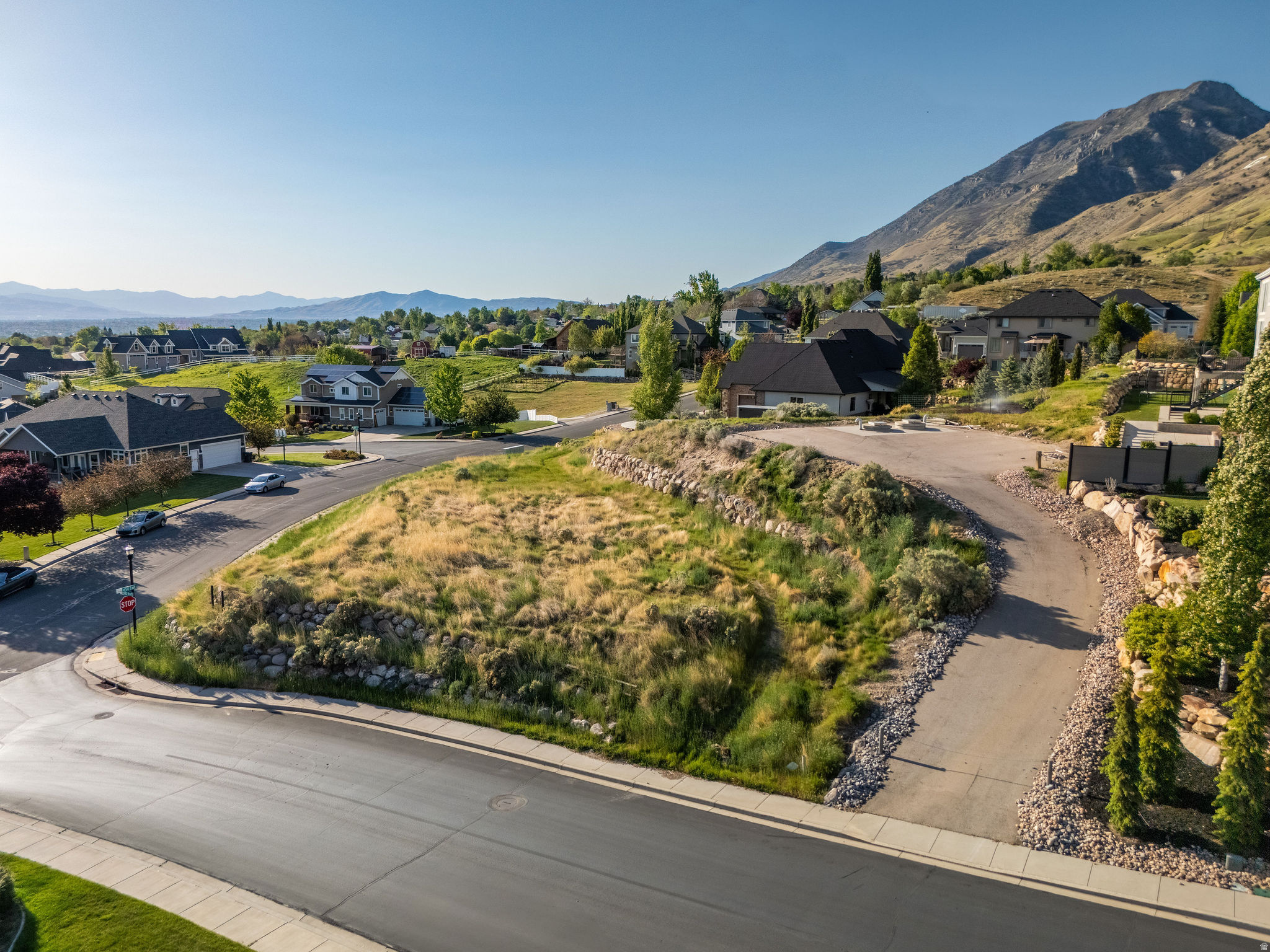 Perched at the foot of the Wasatch Mountains on a half-acre corner lot, this is a rare opportunity to build a custom home in The Highlands at Bald Mountain, an established custom-home community in Lindon. The lot's elevated position delivers sweeping views of the Wasatch peaks to the east and the valley and Utah Lake to the west. As a corner lot, you gain added privacy, flexible setback options, and a natural footprint that allows for creative home design. All utilities stubbed to the lot to the owners knowledge. Easement for Jordan Valley Aqueduct as seen in pictures. This is the last undeveloped lot in the subdivision. Topographical Survey Map available.