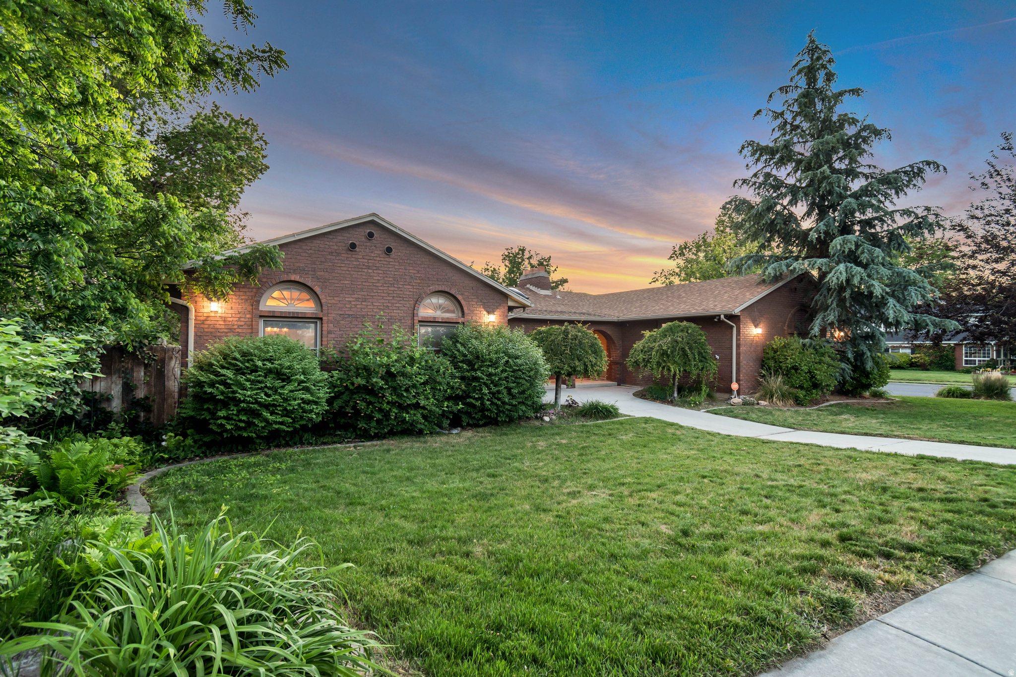 Located in one of Murray's most sought after high end neighborhoods, this home offers a rare opportunity to own in an exceptional area while adding your own personal updates and finishing touches. The property features an open concept layout with vaulted ceilings that create a bright and spacious feel throughout the main living areas. A full two bedroom, one bathroom mother in law apartment with its own second driveway provides incredible flexibility for guests or rental potential. The primary suite opens to a private deck, perfect for relaxing mornings or evenings, while the backyard is highlighted by a gazebo that creates an inviting outdoor retreat. This home combines location, space, and unique features with outstanding long term potential and is being sold as is. VACANT & EASY TO SHOW