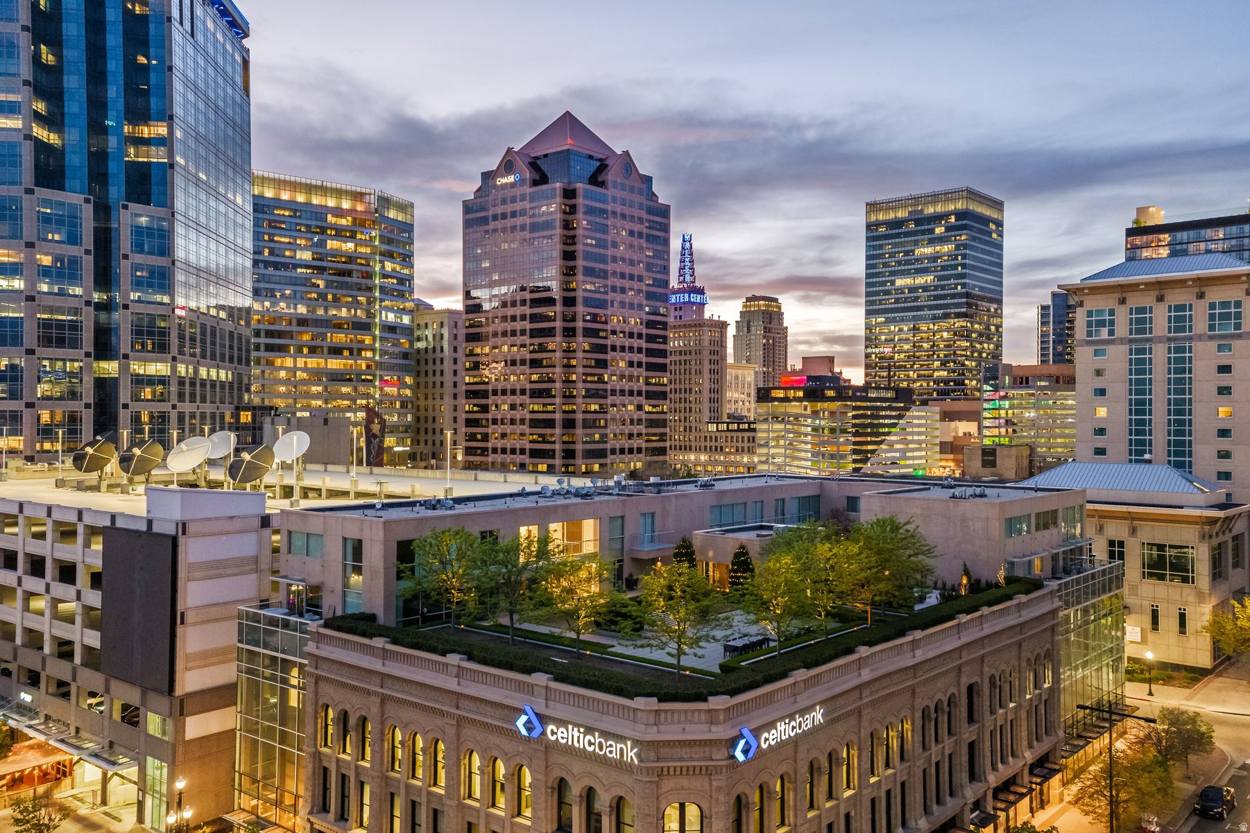 A downtown Salt Lake City rooftop oasis. As you arrive at The Plaza, on the 4th level of this bank building, you instantly feel the uniqueness of the property. Perched above the busy city streets, you are immersed in an incredible park-like space full of mature trees, English row style hedges, patios, a fire pit wrapped with RH lounge furniture, and inviting walkways. This townhome has recently gone through a complete renovation with only the highest quality finishes and craftsmanship, including a marble floor entry, quarter sawn white oak floors, quartzite countertops, custom cabinetry and built-ins, professional light fixtures, solid core doors, polished nickel Rowe and Waterworks fixtures, and designer paint and wall treatments. The floor plan is built around the large family room with vaulted ceilings facing the kitchen with Bosch and Wolf appliances, a huge marble island and a built-in leather banquette. Around the corner is a butler's pantry with wine and pantry storage. Upstairs, the views are even more impressive from the spacious primary suite with an ensuite walk-in closet and a luxurious principal bathroom featuring heated floors and heated mirrors on the built-in medicine cabinets on a wall covered with hand-chipped marble. Within easy walking distance to all the city has to offer, including the best restaurants and bars, the Broadway Cinema Centre, Gallivan Center, Regent Street, Eccles Theater, Capitol Theater, Abravanel Hall and a Marriott Hotel next-door for your guests. You also have two parking spots in the secured garage and easy access to the freeway, meaning you are only minutes from mountain hiking and biking, world class skiing, the Salt Lake International Airport, and much more.