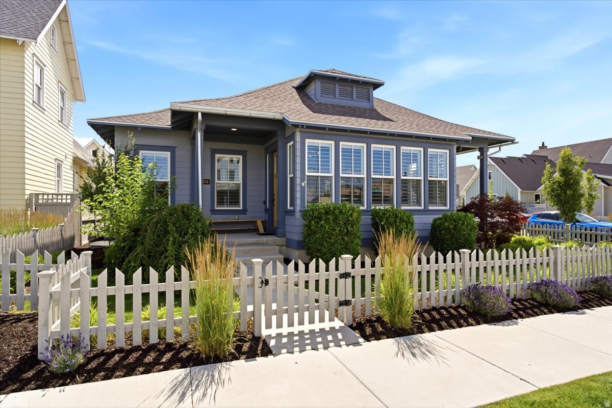 Experience elevated living on Daybreak's exclusive Island. This beautifully upgraded 5 bedroom, 4 bath home features vaulted ceilings, transom windows throughout the first floor, upgraded built in shelving, granite countertops, and an upgraded built in refrigerator. The desirable corner lot offers spacious living areas, a private hot tub, and a 2 car garage with a custom wood workshop approximately 11' by 17', complete with a ventilation and air filtration system. The basement includes a dedicated theater room constructed with double sheetrock walls for enhanced sound deadening-an ideal space for immersive movie nights or gaming. Enjoy access to one of Utah's most sought after walkable communities with nearby trails, parks, shopping, and dining. Luxury, comfort, and lifestyle come together in this exceptional home. Come experience this home today!