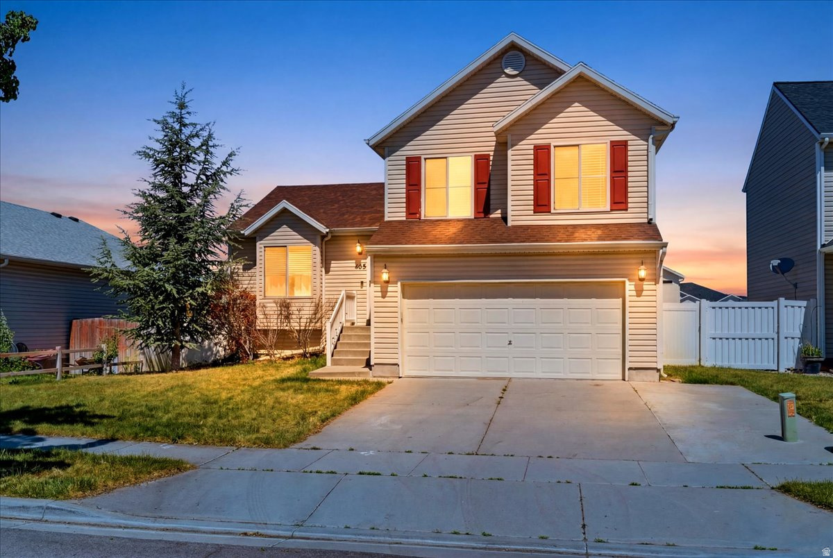 Small-town living with easy access to Downtown Salt Lake City! This Tooele home offers two living areas, a huge fenced backyard, and plenty of parking with a 3-car driveway. Inside, you'll find a bright front room, bamboo wood flooring, and an updated kitchen with granite countertops, dark wood cabinetry, and a dining peninsula with extra seating.  The spacious rear living room opens to a covered patio and backyard with beautiful sunset views toward Stansbury Island and the Great Salt Lake. Upstairs features a large primary bedroom plus two additional bedrooms with mountain views. Downstairs includes a bonus room perfect for a home office and an additional bedroom for guests. New carpet was installed in the bedrooms in 2018, and the roof and water heater were replaced in 2019. Enjoy nearby restaurants, hiking, camping, and fishing in Settlement Canyon and Middle Canyon, with Salt Lake City just about 30 minutes away.