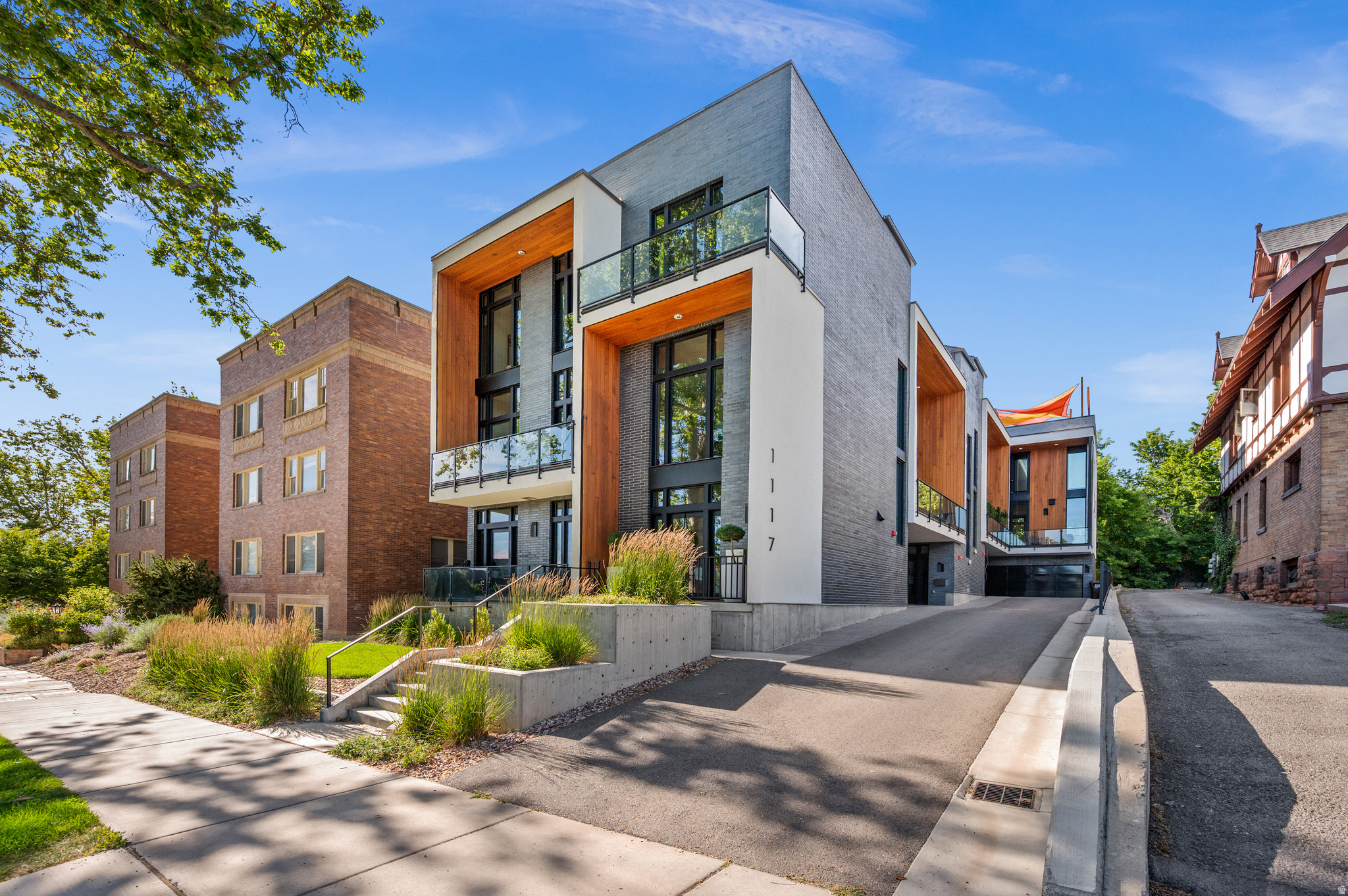 There is something undeniably special about South Temple. Perhaps it's the canopy of mature trees framing one of Salt Lake City's most iconic streets, the architectural character of the historic homes, or the ability to enjoy a peaceful residential setting just moments from downtown. Bordering Federal Heights and within walking distance of neighborhood cafs and restaurants, this is city living at its finest. Welcome to South Temple Place, an exclusive collection of four luxury townhomes. Residence #3 offers a rare blend of sophisticated design, exceptional craftsmanship, and remarkable indoor-outdoor living. Thoughtfully positioned within the building, it feels like a private retreat in the heart of the city. Expansive floor-to-ceiling windows flood the home with natural light, while a 163-square-foot cedar-clad terrace seamlessly extends the main living space outdoors. The true showpiece awaits on the top floor. A spectacular private rooftop terrace, spanning 590 square feet, captures sweeping views of Salt Lake, the downtown skyline, and the Wasatch Mountains. Designed for both entertaining and quiet evenings under the stars, the space features Trex decking, turf, a custom steel pergola, and front-row seating for unforgettable sunsets. Inside, every detail reflects a commitment to elevated design. Engineered walnut flooring, Windsor windows, and a striking custom 16-gauge stainless steel floating staircase-featuring a perforated pattern inspired by the Wasatch Mountains-create a distinctive architectural statement. The kitchen is equally impressive, with premium Bosch appliances, commercial-grade Mirlux high-gloss cabinetry, quartz countertops, and a marble & stainless-steel mosaic backsplash. The upper level features two primary suites, each with a private bath and generous walk-in closet. Additional upgrades include a Lutron whole-home lighting system, new high-efficiency HVAC, in-line water heater, enhanced sound insulation with 16-inch partition walls between residences, and an EV-ready garage. Yes! An attached two car garage! Living here means you are perfectly positioned just minutes from downtown Salt Lake City, the University of Utah, the Shoreline Trail system, and the vibrant 9th & 9th district-with Salt Lake City International Airport just fifteenminutes away-Residence #3 delivers a rare combination of architectural sophistication, modern luxury and urban convenience.