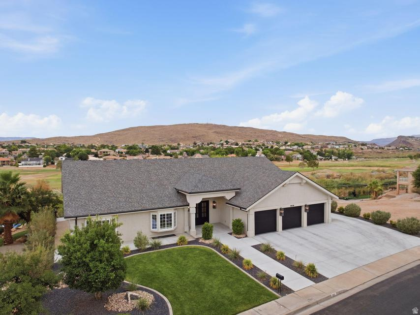 Thoughtfully reimagined from top to bottom, this stunning home blends modern luxury, and panoramic golf course views. Inside, you'll find 5 bedrooms, 3.5 bathrooms, soaring ceilings, expansive windows, designer finishes, a modern fireplace, and a chef's kitchen featuring an oversized island, custom cabinetry, quartz countertops, and premium appliances. The primary suite offers a spa-inspired bathroom with dual vanities, a freestanding soaking tub, oversized walk-in shower, and an impressive custom closet. Step to your backyard from the walk-out basement to expansive covered patios overlooking the beautifully landscaped backyard. Complete with a 3-car garage, RV parking and no HOA, this move-in ready home delivers exceptional craftsmanship, incredible views, and an unbeatable location close to golf, parks, shopping, dining, and more.