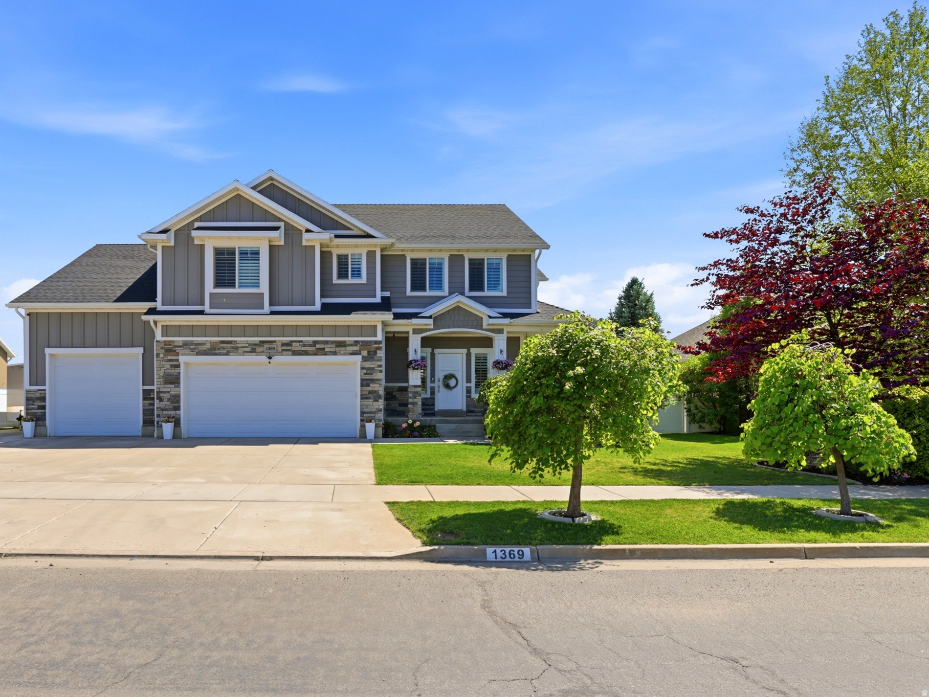 Beautiful north-facing, two-story home built in 2015 with 4,325 sq ft of thoughtfully designed living space on a .24-acre lot. This versatile home offers six bedrooms and 3.5 baths, plus a finished basement that includes a bedroom and full bath, a theater/family room, and a kid-friendly mini rock-climbing wall. The kitchen is a chef's dream with granite countertops, a spacious island, and abundant counter and cabinet space. Plantation shutters run throughout for timeless style and light control. The luxurious master suite features an extra bonus room that can be turned into a home office, workout space, or dressing area.  Additional highlights include an extra-wide, deep four-car garage, and a backyard perfectly suited for entertaining and play. Close to the new corridor and freeway, Layton Hospital, grocery stores, biking/walking trails, and a wide range of dining options. A rare blend of space, features, and location-perfect for growing families seeking comfort and convenience.