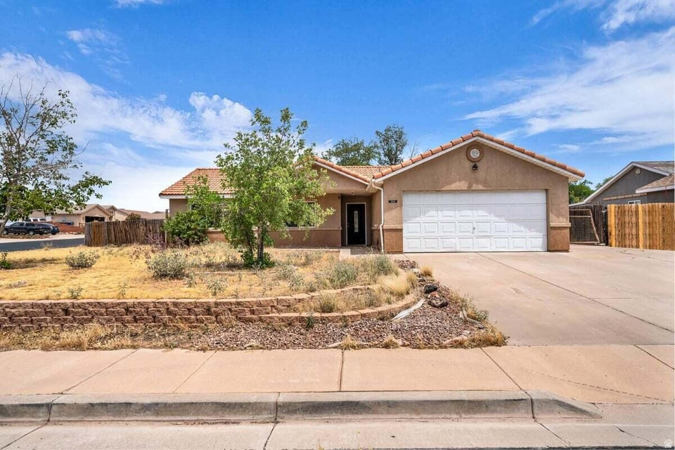 Perfectly situated on a spacious .27-acre corner lot in a peaceful cul-de-sac with NO HOA, this beautifully maintained home offers comfort, functionality, and the best of Southern Utah living. Ideally located nearby Sand Hollow Reservoir, Quail Creek, parks, restaurants, and endless outdoor recreation, you'll enjoy both convenience and a peaceful neighborhood atmosphere. Inside, the thoughtfully designed floor plan features tall, vaulted ceilings and abundant natural light throughout, along with recent updates including a new dishwasher, garbage disposal, refrigerator, and toilets for added peace of mind. The attached oversized 2-car garage and additional RV parking provide plenty of space for vehicles, toys, and extra storage. Step outside to an expansive backyard filled with endless potential, where you can relax beneath the covered patio while taking in the beautiful mountain views. Buyer to verify all information, deemed reliable; however, buyer to verify all info including utilities, rental restrictions, and HOA information if applicable.