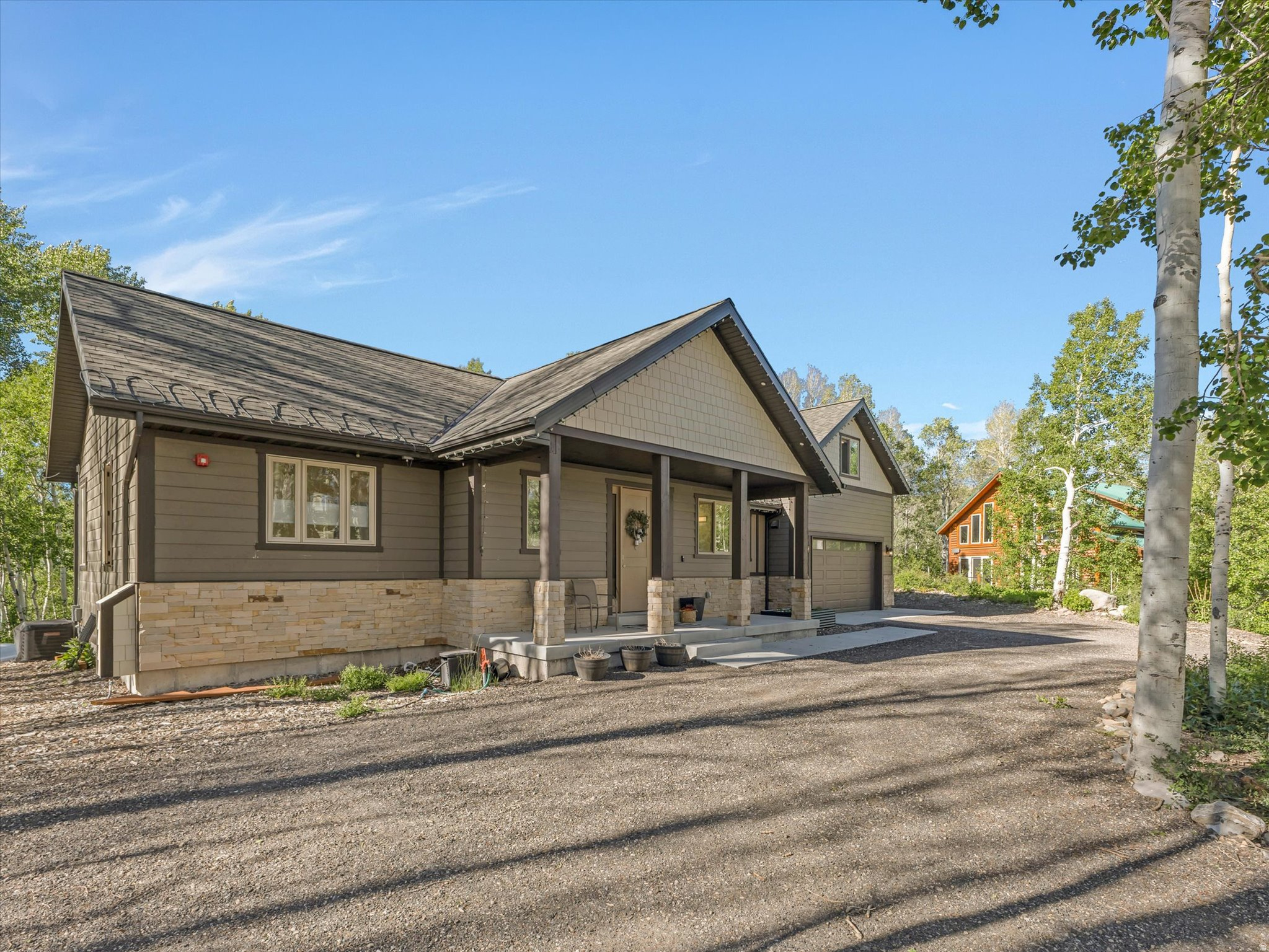 ** SCHEDULE A PRIVATE SHOWING BEFORE 06/21 AND BE ENTERED TO WIN A BLACKSTONE GRILL!!** Welcome to mountain living without the maintenance. Tucked into one of the area's most beautiful communities, this lock-and-leave home offers the rare blend of a peaceful mountain escape with quick access to major cities, dining, shopping, and everyday conveniences.  From the moment you arrive, it feels like you've checked into a mountain retreat-fresh air, beautiful surroundings, and a sense of calm that doesn't wear off. As an owner in this prestigious community, you'll enjoy exclusive access to private hiking trails and lakes, offering year-round outdoor recreation just outside your door.  Inside, the home is designed for effortless single-level living. Every bedroom has been thoughtfully crafted with its own ensuite, giving everyone their own space, privacy, and comfort. The layout works just as well for hosting as it does for quiet, everyday living.  Step outside to a massive covered back deck-built for year-round entertaining, morning coffee, or simply taking in the mountain air no matter the season. Whether you're looking for a full-time residence, a part-time getaway, or a smart investment opportunity, this home delivers flexibility, luxury, and true lock-and-leave ease in a setting that feels like a permanent vacation.