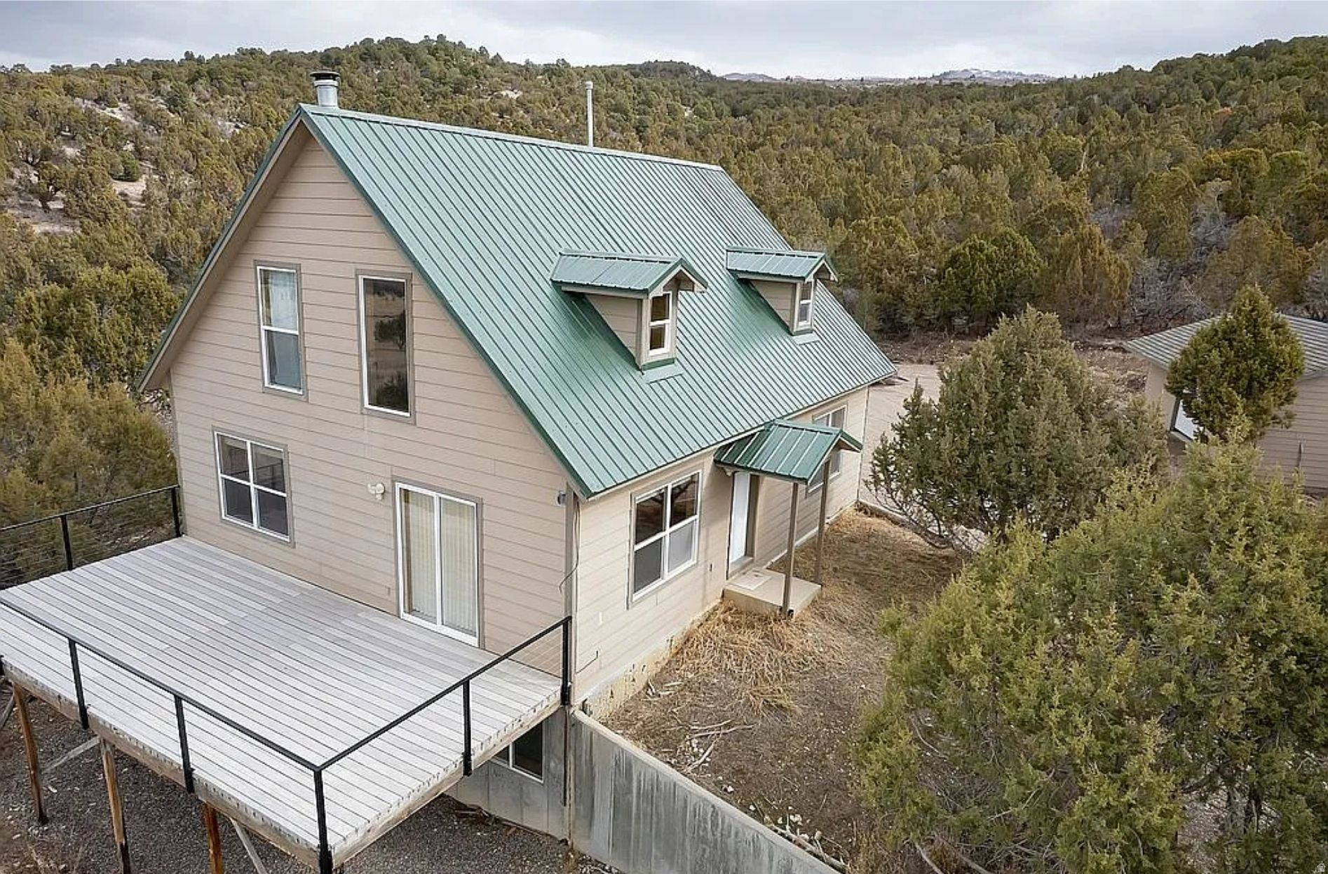 Escape to your own private mountain retreat in Freedom Ranch, a gated community just 10 minutes from downtown Mount Pleasant. This 2,419 sq ft cabin offers the perfect blend of remote, self-reliant living and everyday convenience, with room to work, play, and truly unwind.    Inside, the main floor features an open-concept kitchen and living room, a convenient laundry room, and a main-floor master bedroom. A large loft overlooks the great room and adds flexible space for guests, hobbies, or a cozy reading area. The daylight basement includes two additional bedrooms, a dedicated room that's perfect for a home office, a comfortable family room, and a large storage room for gear and supplies.    Set on 5.9 acres at the foot of the mountains, the property is surrounded by trees and long-range views in every direction-deer and elk are frequent visitors right outside your windows. The home is heated and cooled by an efficient split system on each floor, and a wood/coal-burning stove in the living room can easily heat the main level and loft for classic cabin comfort. Washer, dryer, and refrigerator are included, so you can move in and start enjoying the space right away.    For those interested in off-grid or backup capability, the property offers a solar energy system with 18 solar panels, inverter, and batteries, available for an additional $20,000. The community well is backed by solar power, providing added peace of mind that water remains available even if the grid goes down. A 20' x 30' garage and a 28' x 40' shop provide ample covered parking, storage, and workspace (all items pictured in the shop and garage are excluded from the sale).    Whether you're looking for a full-time residence, a secure mountain getaway, or a base for remote work and recreation, this Freedom Ranch cabin delivers privacy, safety, and the potential for a truly independent lifestyle-without sacrificing quick access to town amenities. Contact Owner directly with any questions. Buyer and buyers agent acknowledges that it is the intent of the Seller to structure this transaction as a tax-deferred exchange under IRC Section 1031, and agrees to cooperate in this exchange, including executing any necessary documents. Buyer must include 1031 Exchange ADDENDUM TO REAL ESTATE PURCHASE CONTRACT