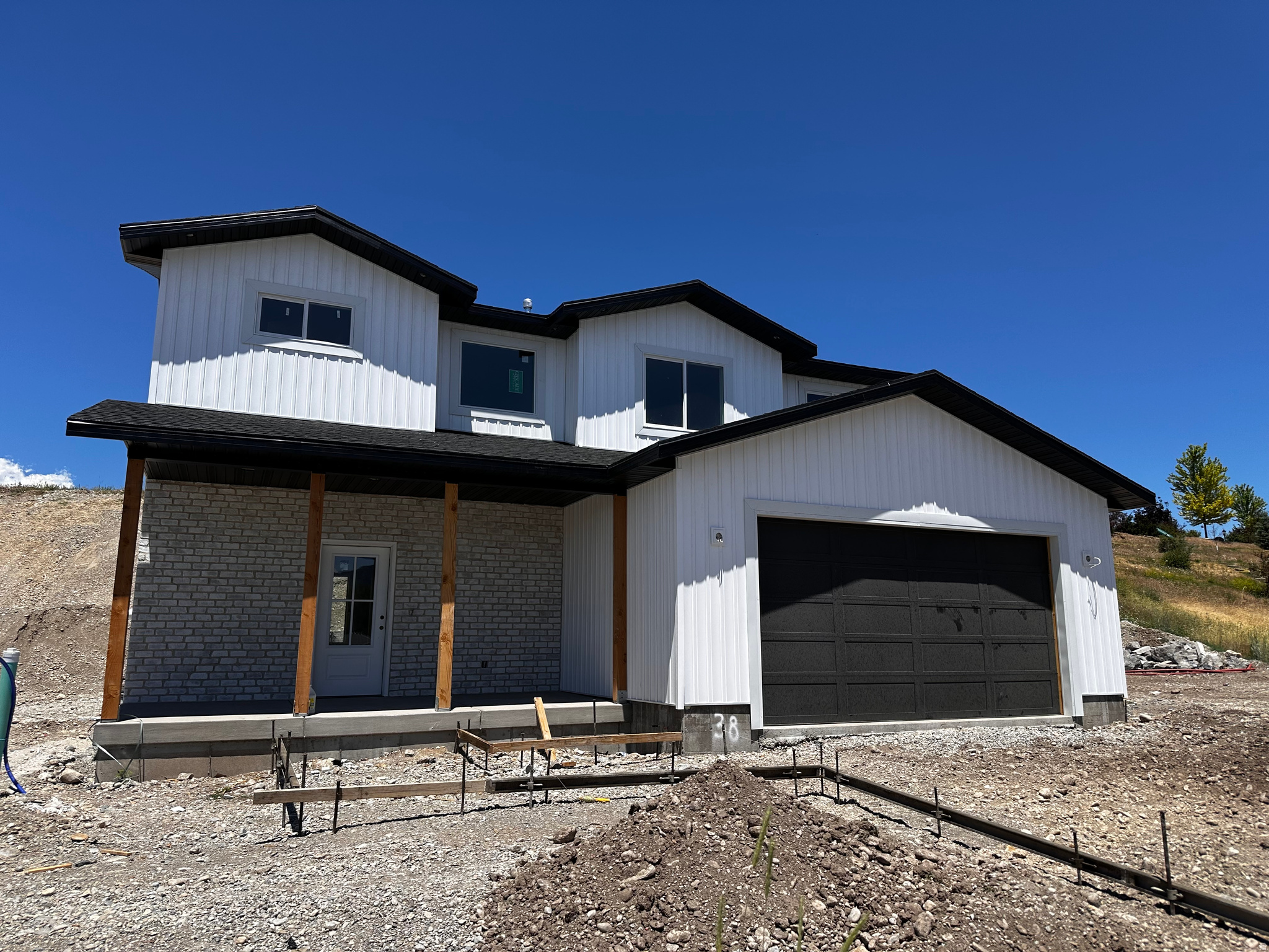 Beautiful new construction 2055 sqft home just below Smithfield Canyon with mountain and valley views you'll never get tired of. This home was designed to feel open and bright with large windows, 9' ceilings, tall ceilings over the open-railing stairs, and a great flowing layout. The kitchen features ceiling-height cabinets, a huge pantry (4.5x10'), oversized island (4x5'), and modern linear fireplace (65") that gives the space a clean custom feel. The primary suite includes a large soaker tub, walk-in tiled shower, and oversized closet. You'll also love the large front porch, finished insulated garage, mudroom, and extra space on the side for RV parking, a future shop, garden, or toys. No HOA. No future neighbors to the east and located in one of Smithfield's most desirable growing areas just minutes from town.  Square footage figures are provided as a courtesy estimate only and were obtained from CORE. Buyer is advised to obtain an independent measurement.  NOTICE: Appointments required to tour, active construction zone - no trespassing, enter at own risk.