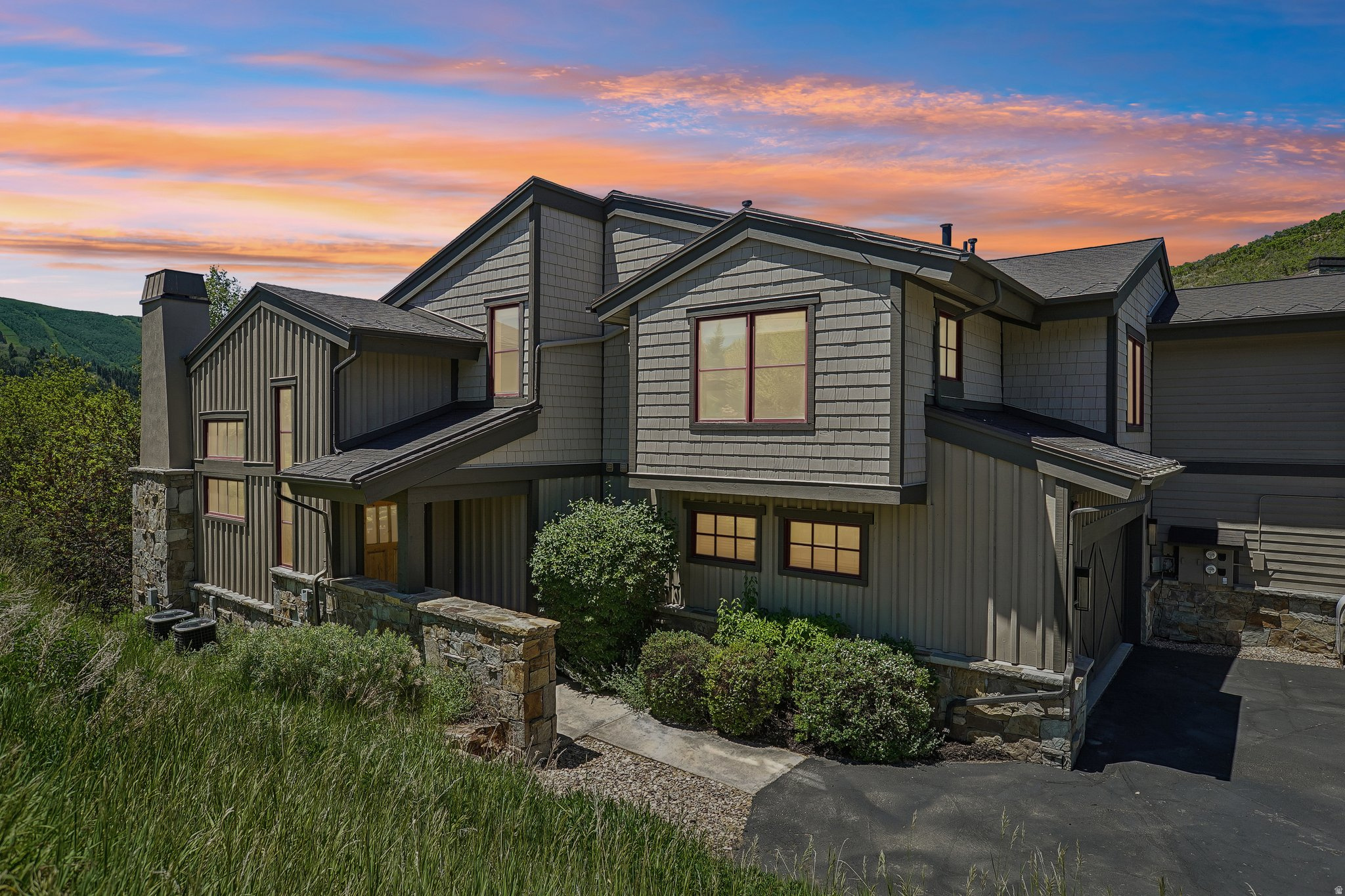 Enjoy a rare private setting perched above the heart of Deer Valley, offering the perfect balance of seclusion, convenience, and mountain luxury. Featuring ski slope views and space for a large group and then some, this three-level home sets the stage for the perfect ski retreat, summer fun or year-round residence. Thoughtfully designed with a downhill-build configuration, the home provides the ease of main-level living while maximizing privacy, views, and access to the outdoor spaces below. Inside, the remodeled interiors are warm and inviting, featuring a beautifully updated kitchen, remodeled bathrooms, designer finishes, warm wood accents, and an oversized stone fireplace. Capture the views of Park City Mountain through the many thoughtfully placed windows that bring in an abundance of natural light, or from the main level deck with a gas stubbed BBQ. New Electric blinds recently installed allowing for effortless mood setting. A second stone fireplace downstairs opens to one of the property's most exceptional features, a remarkably private backyard retreat. Surrounded by mature aspens, the spacious patio and hot tub area provide a secluded sanctuary for relaxing, entertaining, and enjoying the peaceful mountain setting. With one of the best locations in Park City, just minutes from Main Street, Deer Valley Resort, and Park City Mountain, you and your guests will enjoy convenient access to world-class skiing, dining, shopping, and recreation. Highlights include five bedrooms, an oversized two-car garage, air conditioning, and an exceptionally private outdoor living environment rarely found this close to town. Seldomly does a home offer this combination of privacy, updated finishes, and premier Deer Valley convenience. Don't miss this opportunity - call today to experience this special home.