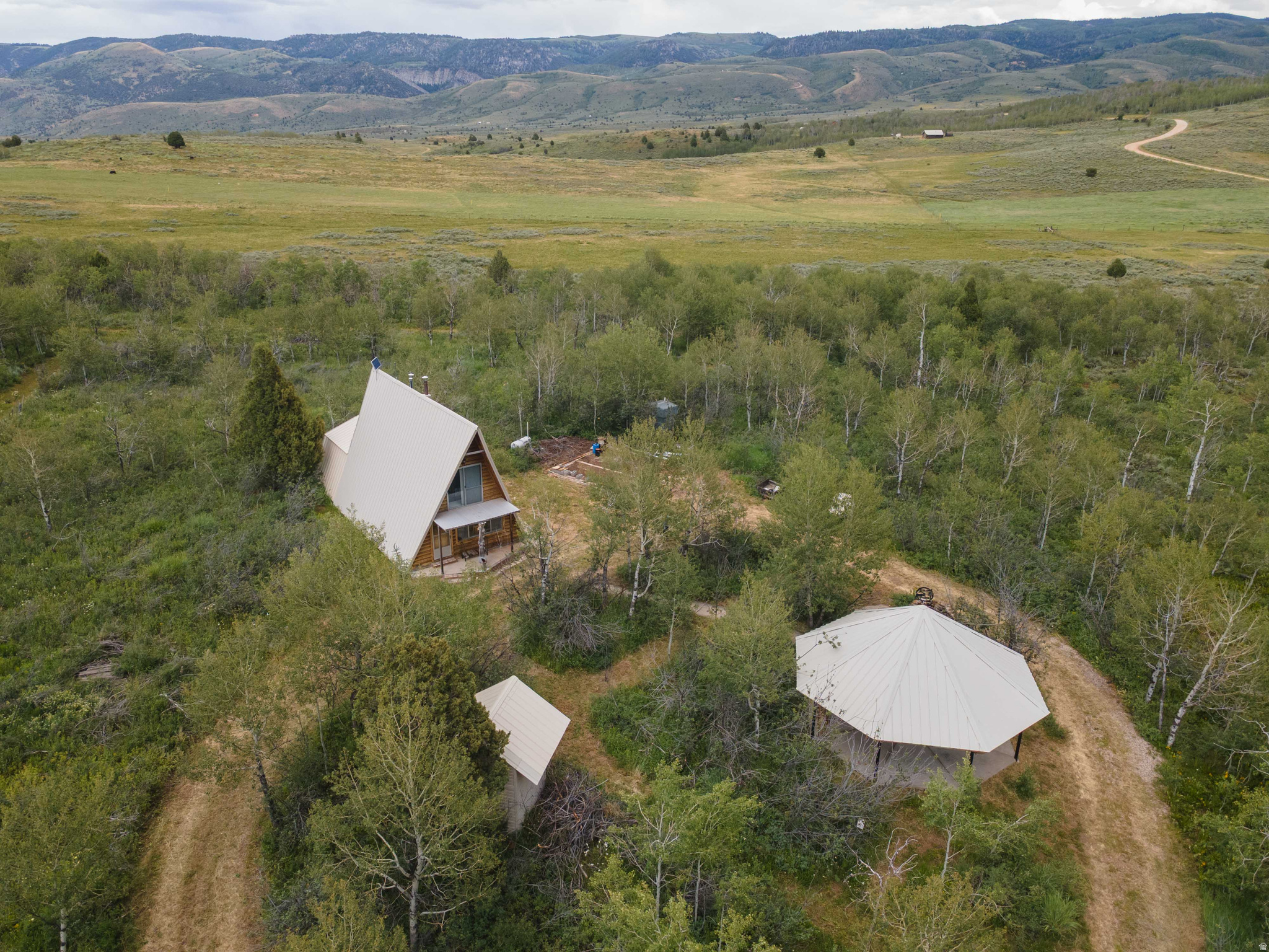 A Scare Canyon Legacy Property awaits the perfect buyer to make it their own. This ruggedly refined retreat was built by Ray Gibbons with the precision of an engineer, and praised by a local builder as a project begun from the ground up and finished with love. Ray's wife created a tidy, entertaining space that's the quintessential gathering place. Let's escape to the mountains and claim this charming home. Property highlights: - 1-bedroom plus loft, 1.5 baths - 1,100 square feet of thoughtfully designed living space - Nestled on 2.34 private acres off Ant Flat Road in Cache County - Located behind a gated Scare Canyon entrance with excellent road accessibility - Surrounded by aspens and abundant wildlife - a serene year-round mountain haven - Fully equipped kitchen, wood-burning fireplace, and propane heaters for comfort - Pressurized water system and a private well - Sold fully furnished and as-is - Large pavilion with a cement floor ideal for gatherings - Circular driveway for easy access - Propane tank, solar in place, with footing for a garage Why you'll love it: This cabin offers the perfect balance of seclusion and convenience, whether you're seeking a weekend retreat, a hunting basecamp, or a winter snowmobiling escape. The property's craftsmanship speaks to its legacy, while the expansive pavilion invites memorable gatherings against a stunning high-mountain backdrop. Important notes: - Winter access is by snowmobile or snowcat; roads are not plowed in the winter months - A true off-the-beaten-path gem located between Weber and Cache counties Ready to write the next chapter of your mountain story? Schedule a tour and experience the privacy, tranquility, and character of this one-owner legacy property.