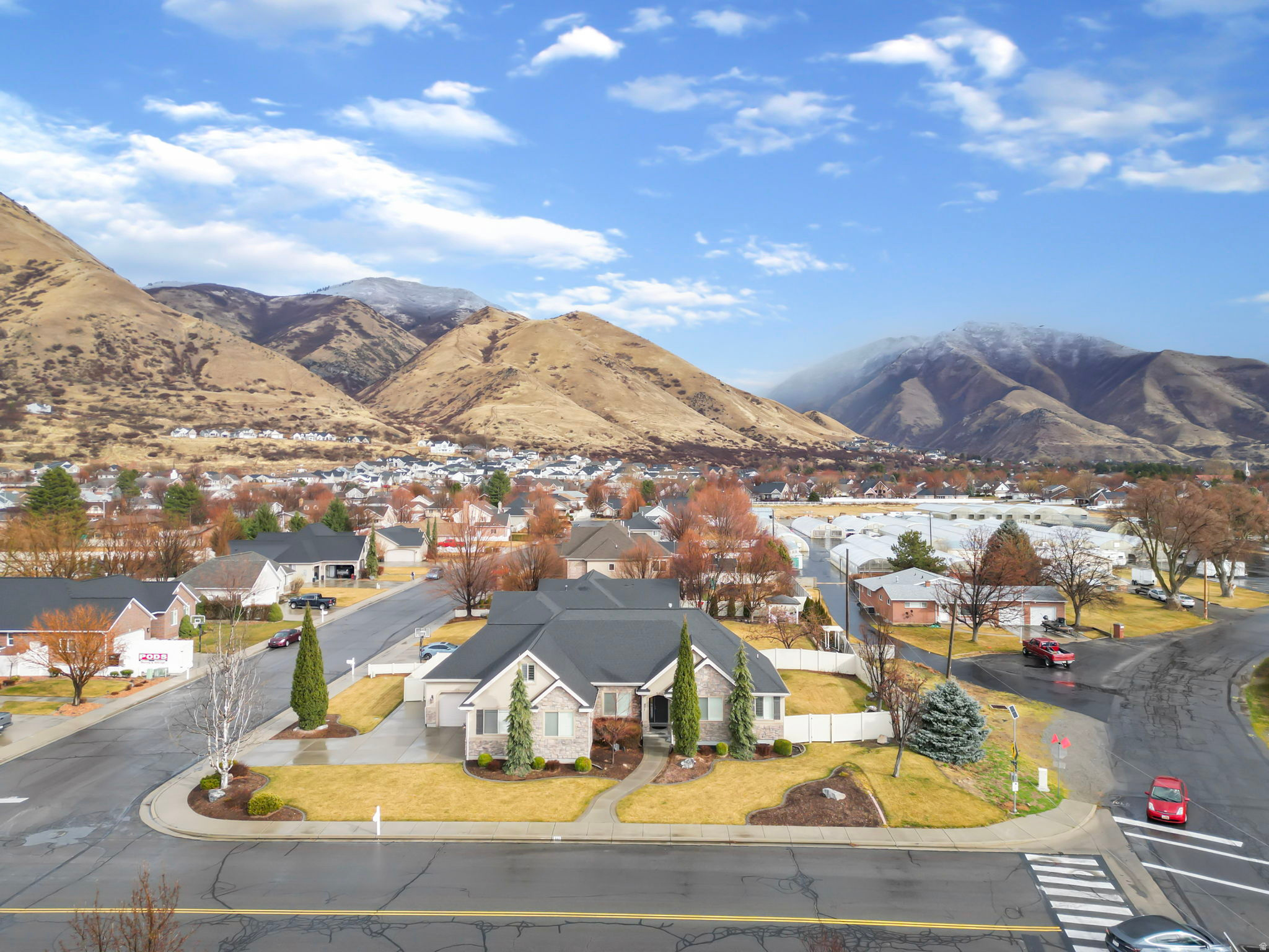 Situated along the prestigious East Bench of Springville, this exceptional six-bedroom, four-and-a-half-bath rambler captures sweeping mountain views and offers a refined blend of elegance, comfort, and versatility. Thoughtfully designed for single-level living on the main floor, the home provides the convenience of everyday essentials all within easy reach while still offering generous space to gather and entertain. Large windows frame the surrounding peaks and fill the open-concept living areas with natural light, creating a seamless connection to the breathtaking landscape. The kitchen serves as the heart of the home, designed for effortless entertaining and comfortable daily living, with ample space to host and gather. The primary suite is positioned for privacy and relaxation, featuring a beautifully appointed ensuite bath and a spacious layout that feels both luxurious and serene. Carefully selected finishes and timeless architectural details enhance the home's elevated feel throughout. The fully finished lower level introduces a private mother-in-law apartment with its own exterior entrance, offering complete independent living quarters. Whether accommodating multigenerational living, extended guests, or providing income potential, this space delivers flexibility without compromise. Located in one of Springville's most sought-after hillside neighborhoods, this residence pairs scenic mountain surroundings with thoughtful design and everyday practicality - all just minutes from outdoor recreation, dining, and convenient commuter access.  Square footage figures are provided as a courtesy estimate only and were obtained from county records.  Buyer is advised to obtain an independent measurement.