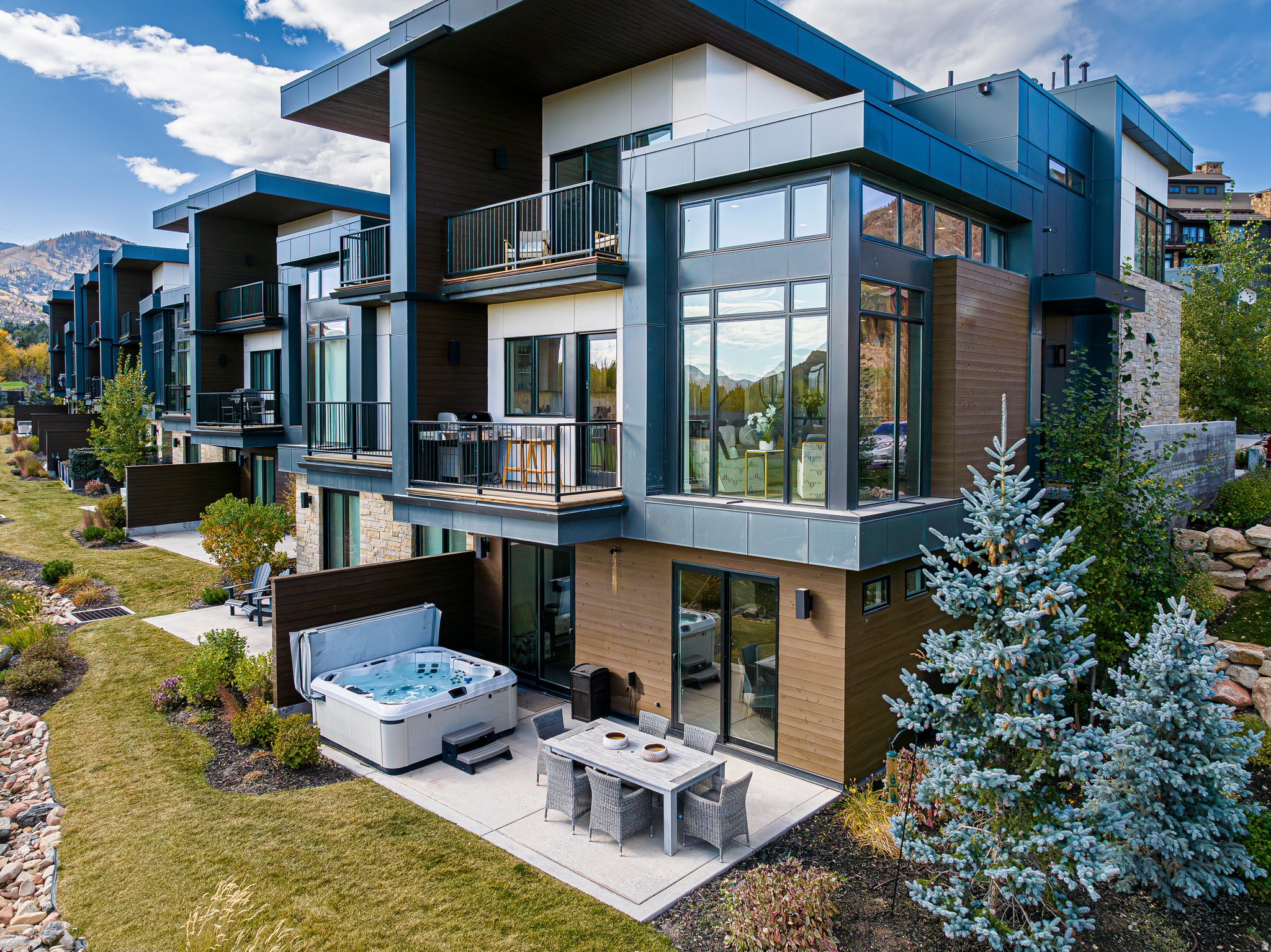 Viridian Residence 12 is a masterfully designed, fully furnished move-in-ready mountain contemporary townhome, situated on a prime row-end along the 11th hole of the Canyons Golf Course. Built in 2020 on the tranquil perimeter of Canyons Village, this residence offers a rare blend of seclusion and accessibility--just steps from the Frostwood Gondola and minutes from the world-class slopes of Park City Mountain Resort.The home's open concept layout is defined by soaring ceilings and great room floor-to-ceiling windows that bring the outside in. In brilliant natural light at the heart of the main level, a gourmet kitchen features premium Italian Bertazzoni appliances and clean, modern finishes. Upstairs, the primary suite serves as a sophisticated sanctuary, complete with a cozy fireplace, and a private deck overlooking the 11th fairway and Uintah Mountains in the east. Two additional ensuite bedrooms and laundry set complete the upper level. The walk-out lower level is designed for entertaining, featuring a fourth ensuite bedroom with a double vanity, a spacious media room with a breakfast bar, and a second laundry set. Outside, a private patio with a hot tub offers the perfect spot to unwind. Owners also enjoy a two-car garage with ample storage for outdoor gear, access to the community's all-season pool, and close proximity to the Waldorf Astoria's renowned dining and spa. Whether chasing winter powder or summer greens, Viridian Residence 12 represents the pinnacle of mountain four-season luxury living.