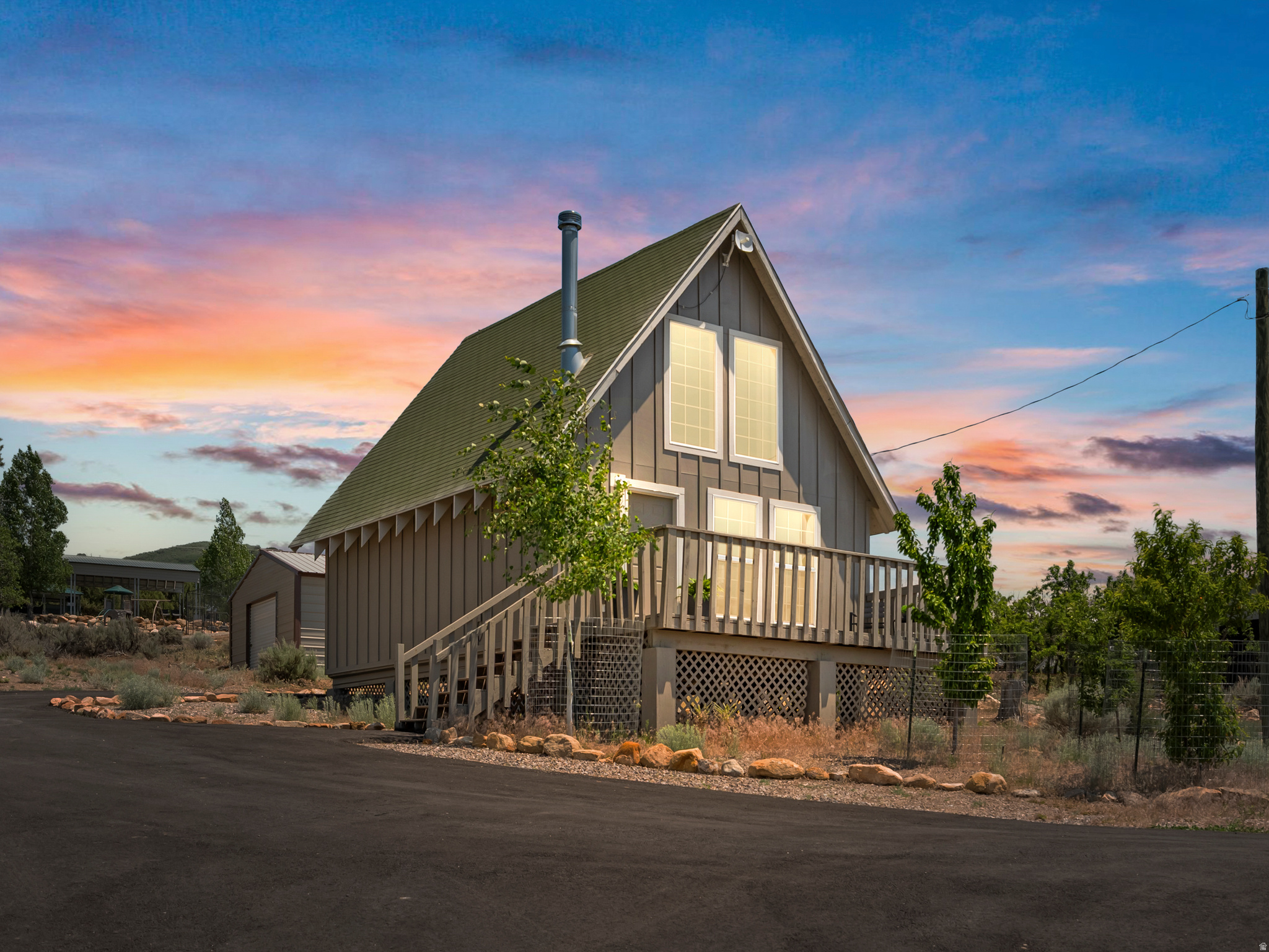 Escape to your mountain retreat in the heart of Fairview's recreation paradise! This beautifully updated cabin has seen extensive improvements, making it the perfect blend of rustic charm and modern convenience. Recent upgrades include a board-and-batten exterior, electrical improvements, increased attic insulation, updated plumbing, a fully remodeled bathroom with the addition of a window for natural light, new flooring throughout the main level, a newly paved driveway with RV parking, and a new refrigerator and stove. Upstairs is plumbed for a second bathroom (ask agent to locate). Comfort is ensured year-round with both a cozy wood-burning stove and a mini-split system to provide heating and air conditioning. Outside, you'll find plenty of room for all your outdoor toys. The expanded and paved driveway, dedicated RV pad, and impressive 20x25 ft garage with roll-up doors on both ends provide exceptional storage and access for ATVs, snowmobiles, trailers, and equipment. Enjoy endless outdoor recreation right at your fingertips, including golfing, miles of ATV riding, hiking, swimming, fishing, and snowmobiling. Located within a gated community, this lot is year-round accessible with community snowplowing. You can enjoy access to outstanding amenities, including a tennis court, pickleball, a golf course, swimming pool, playground, pavilion, RV and camping sites, and 24-hour resort restroom and shower facilities. The cabin has washer and dryer hookups, and the office includes a coin laundry for owners to use as well. Experience the best of mountain living while remaining conveniently located within approximately 10 minutes of grocery stores, dining, and local events in Fairview. Enjoy your own private slice of the outdoors without sacrificing convenience. Square footage figures are provided as a courtesy estimate only and were obtained from county records. Buyer is advised to obtain an independent measurement.