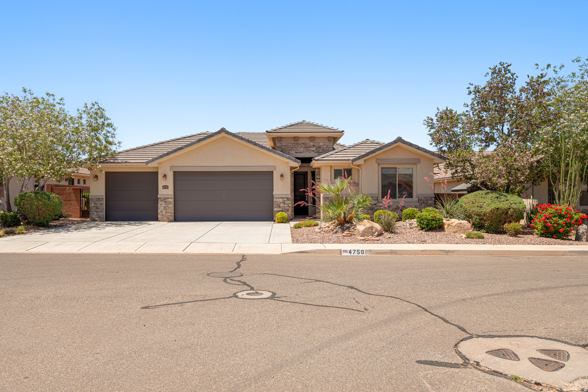 EASY LIVING IN WARNER GATEWAY | Located in Warner Gateway in Washington Fields, this well-kept home has been lightly used as a second home by the original owners and still feels fresh and move-in ready. The single-level layout includes 3 bedrooms and 3 bathrooms, with ensuite access for every bedroom, a setup that works especially well for guests or anyone wanting a little extra privacy. The main living area feels open and comfortable, with wood-look tile flooring throughout the common spaces for easy upkeep. The kitchen features quartz countertops, generous cabinet storage, and a layout that connects naturally to the living and dining areas without feeling overly open or crowded. Recent updates include fresh interior paint, upgraded lighting, a new tankless water heater, and a water softener. Outside, the xeriscaped yard keeps maintenance simple while still offering great curb appeal. The attached three-car garage provides plenty of room for vehicles, storage, bikes, or weekend gear. The neighborhood pool is just a short walk away, and the location puts you close to Highway 7, the airport, the new Washington All-Wheels Park, and growing Washington Fields destinations like The Paseos. Easy to maintain, easy to lock and leave, and in an area that continues to grow in all the right ways.