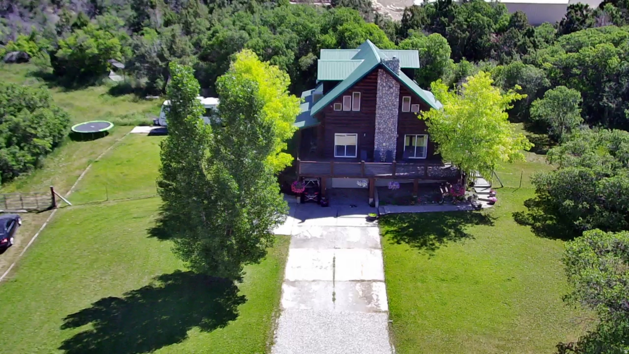 Mountain log retreat with walkout ADU just minutes from the newly opened Snowland ski lift and resort. Perched above the charming town of Fairview, this beautifully crafted log home offers privacy, sweeping valley views, and a level of flexibility rarely found-set against a stunning mountain backdrop. Large windows throughout the home capture natural light and expansive views, creating a warm and inviting open-concept living space. The main level features a spacious layout, a well-appointed kitchen with custom finishes, and seamless flow for entertaining or everyday living. With 5 bedrooms and 3 bathrooms, the home includes a newly added master-size bedroom in the walkout basement, transforming the lower level into a true private suite. Complete with its own living area, kitchen space, bathroom, and additional bedrooms, the walkout basement offers ideal flexibility for guests, multi-generational living, or potential rental use. Upstairs, the primary suite provides a quiet retreat with generous space, a private bathroom, and direct access to an outdoor patio. Just beyond, a secluded hot tub tucked into a mature oak forest creates the perfect setting to relax and unwind under the stars.