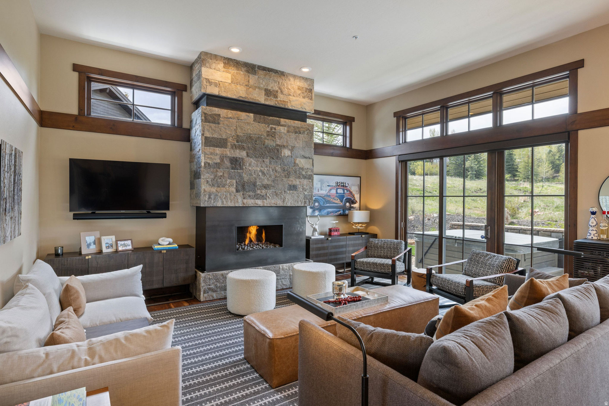 Alder & Tweed Designed, Furnished & Turnkey on the 11th Fairway. There aren't many homes where you can watch a golf shot land from your kitchen window. This Park Meadows residence sits along the 11th fairway, and the setting shapes everything - the window placement, the deck, the rhythm of daily life here. The home was designed and fully furnished by Alder & Tweed, one of Park City's most celebrated interior design firms, known for their ability to make mountain living feel both elevated and genuinely livable. Their work here is no exception - every finish, fixture, and furnishing was chosen with intention, and it shows. The Alder & Tweed design package conveys with the sale, meaning this home is truly move-in ready from day one. Inside, the home moves well. Stone fireplace, soaring ceilings, striking lighting. The floor plan flows from the great room through to the kitchen in a way that makes gatherings feel easy rather than engineered. Every bedroom is ensuite, and the primary suite has a private deck that earns its keep in every season. Out back, the landscaped yard, spacious deck, and hot tub all face the fairway. The oversized three-car garage handles the rest - skis, golf clubs, bikes, pickleball paddles, tennis rackets. Park City doesn't ask you to choose a season. This home makes sure you're ready for all of them. Trails, skiing, golf, hiking, and Historic Main Street are minutes away. Park Meadows doesn't come up often. This one is worth paying attention to.