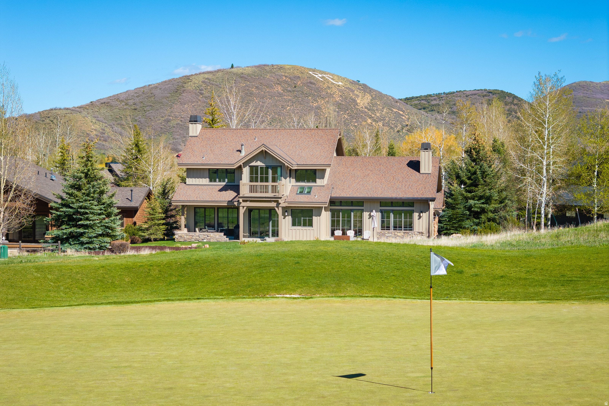 Alder & Tweed Designed, Furnished & Turnkey on the 11th Fairway. There aren't many homes where you can watch a golf shot land from your kitchen window. This Park Meadows residence sits along the 11th fairway, and the setting shapes everything - the window placement, the deck, the rhythm of daily life here. The home was designed and fully furnished by Alder & Tweed, one of Park City's most celebrated interior design firms, known for their ability to make mountain living feel both elevated and genuinely livable. Their work here is no exception - every finish, fixture, and furnishing was chosen with intention, and it shows. The Alder & Tweed design package conveys with the sale, meaning this home is truly move-in ready from day one. Inside, the home moves well. Stone fireplace, soaring ceilings, striking lighting. The floor plan flows from the great room through to the kitchen in a way that makes gatherings feel easy rather than engineered. Every bedroom is ensuite, and the primary suite has a private deck that earns its keep in every season. Out back, the landscaped yard, spacious deck, and hot tub all face the fairway. The oversized three-car garage handles the rest - skis, golf clubs, bikes, pickleball paddles, tennis rackets. Park City doesn't ask you to choose a season. This home makes sure you're ready for all of them. Trails, skiing, golf, hiking, and Historic Main Street are minutes away. Park Meadows doesn't come up often. This one is worth paying attention to.