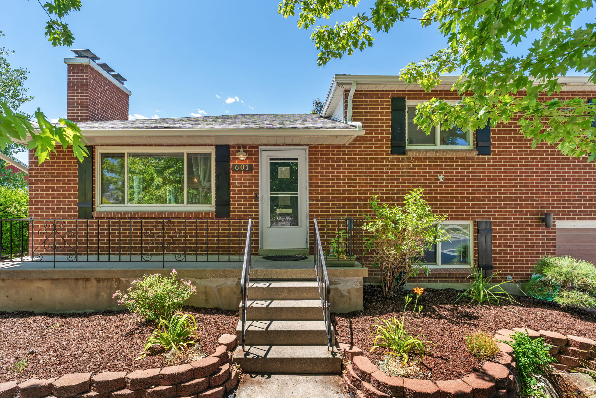 Tucked away on a quiet street, this move-in ready brick split-level is an everyday escape boasting a private backyard sanctuary and detached studio. The main floor features an open flow, updated windows, and a wood-burning fireplace. Original hardwood floors run through the main living areas and continue under the upstairs bedroom carpets, while a skylight brightens the upper hallway. * Downstairs, a versatile large bedroom addition features a generous walk-in closet and French doors opening directly to a backyard waterfall. The finished lower basement adds a spacious family area, dry bar, cold storage, and a utility closet. * Furnace, central AC, and humidifier replaced in 2022. Fresh neutral paint, recently cleaned carpets, secure keyless entry, and major appliances included. * Low-maintenance, xeriscaped front yard. The fully fenced backyard is a private retreat featuring an eco-conscious, water-wise lawn, redwood deck, hot tub, custom pond with streams, mature wisteria, and raised garden beds. * A fully finished, year-round 2-room outbuilding includes electric heat, ceiling fans, and a hardwired LAN line - ideal for a distraction-free home office or workshop. * 1-car garage with insulated door. Located near an elementary school with no busy streets to cross, and just minutes from Fashion Place Mall, grocery stores, and freeway access.