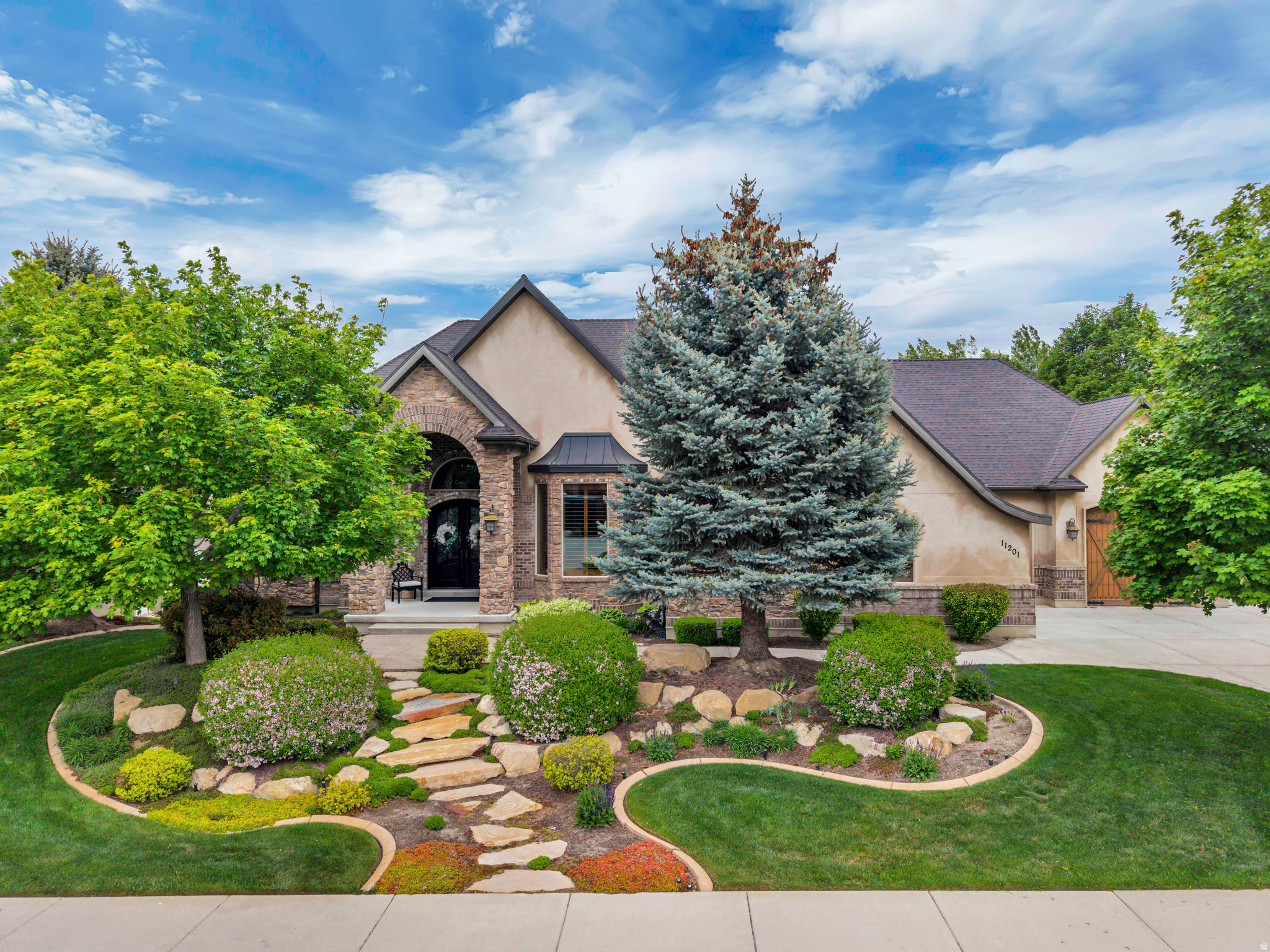 Beautifully maintained and thoughtfully designed, this charming rambler offers ideal main-level living with a layout that feels both functional and elevated. Vaulted ceilings and large windows fill the home with natural light, creating an open and inviting feel throughout. The kitchen is designed for both everyday living and effortless entertaining, featuring a large center island, generous workspace, and a seamless, functional flow throughout. The luxurious main floor primary suite offers a spacious walk-in closet along with a separate tub and shower. The flexible floor plan also includes an office that can easily function as additional ensuite living, while the formal dining room offers the option to be used as a formal sitting or living room depending on your needs. French doors open to a private, enclosed backyard that has been meticulously manicured and thoughtfully designed for both relaxation and entertaining, complete with mature landscaping, a custom water feature, and multiple outdoor gathering spaces that offer exceptional privacy and seclusion. The oversized 3-car garage and additional RV / Boat parking provide ample space for vehicles, storage, and recreational needs. The walkout basement is equally impressive, featuring a full second kitchen, expansive open living spaces with high ceilings, and direct access to the backyard patio. Perfect for entertaining, multi-generational living, guests, or long-term flexibility, the lower level feels like a true extension of the home rather than a separate space, with generous natural light throughout. Ideally located just minutes from freeway access and everyday amenities while still tucked into a quiet, mature neighborhood, this home offers a rare combination of luxury, layout, privacy, and convenience that truly checks all the boxes. Buyer/Buyer's agent to verify all info.