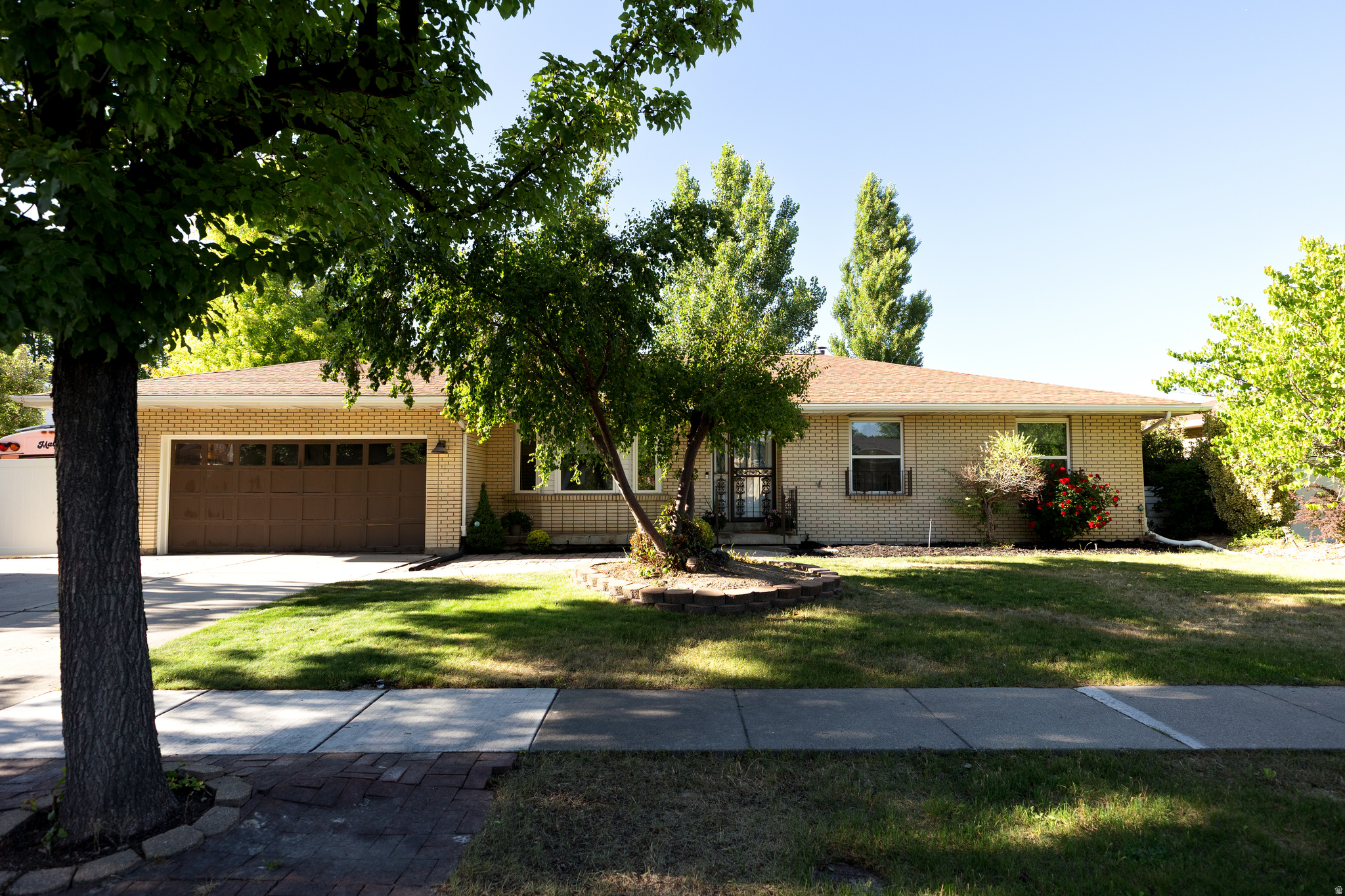 This beautiful, well cared for classic rambler is located on a lovely tree-lined street in a very desirable Murray neighborhood. You will love the gorgeous custom kitchen complete with SS KitchenAid appliances, glowing granite countertops, ample work spaces and tons of storage! It connects to a welcoming family room with a cozy gas fireplace and access to the lovely backyard. There are newer windows upstairs, a newer roof, dryer, blinds, water heater and smart sprinkler system. You will love relaxing on the covered patio after a long day and or entertaining family and friends there. The basement has a fun family room with cool retro wet bar and wood burning stove.  There is also an awesome craft room that has laundry hookups & a fantastic workshop ready for your projects.  This home has been loved and the neighborhood has been cherished as well.  This is a rare find in this wonderful Murray community.  Come and see it today!