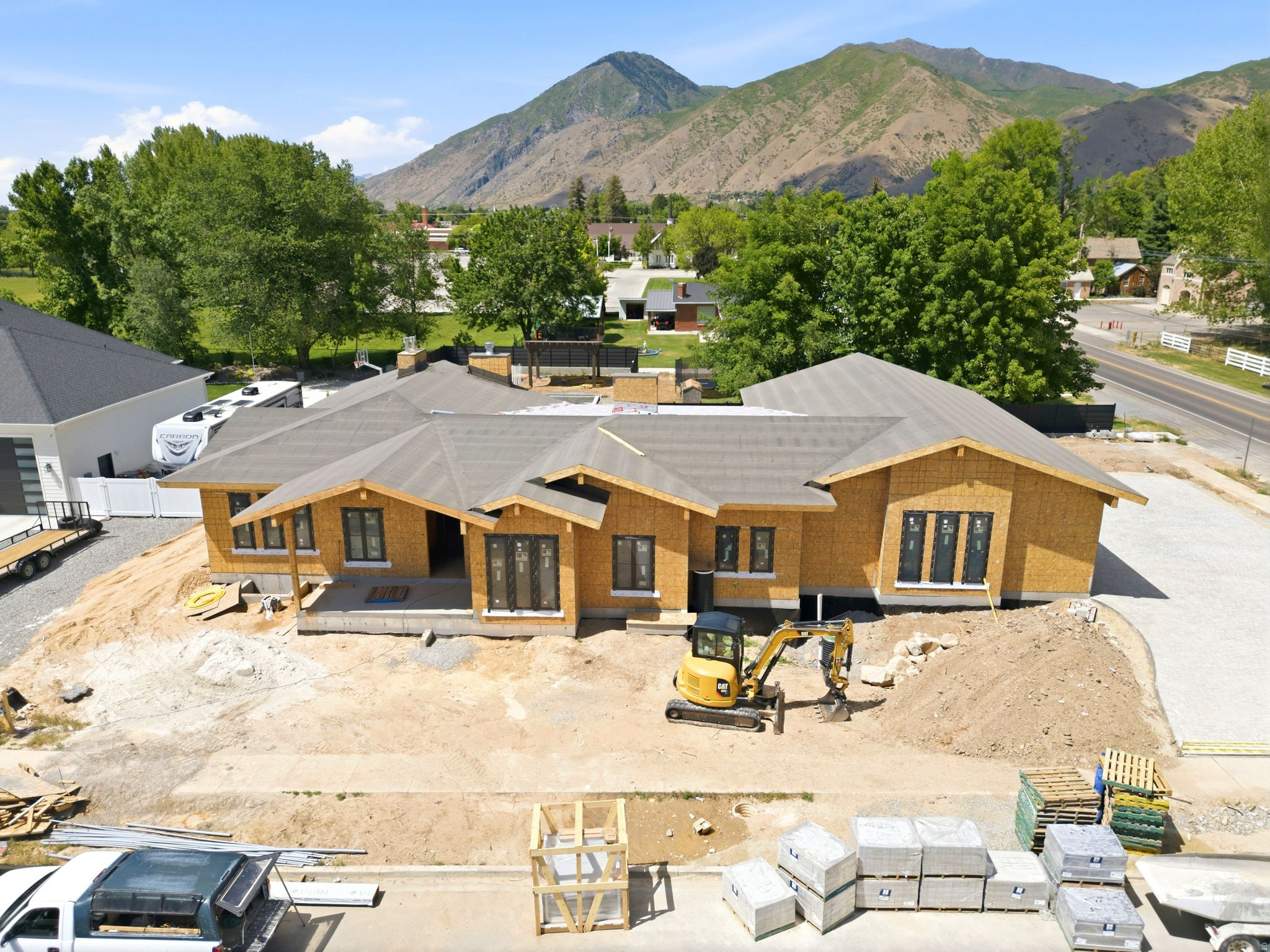 Currently under construction, this extraordinary custom estate offers over 7,700 square feet of thoughtfully designed living space, combining timeless architecture, premium finishes, and exceptional attention to detail. Every element of the home has been carefully selected to create a refined living experience that balances luxury, comfort, and functionality. The impressive chef's kitchen is appointed with premium Wolf and Sub-Zero appliances, custom cabinetry, and designer finishes, while a fully equipped lower-level kitchen featuring GE Caf appliances provides additional flexibility for entertaining and everyday living. Throughout the home, you'll find real hardwood flooring on the main level, stunning tongue-and-groove ceilings, designer accent walls, and multiple fireplaces that add warmth and character throughout the residence. The main-level primary suite serves as a private retreat with spa-inspired finishes and luxurious appointments. Additional highlights include three separate laundry areas, high-efficiency zoned HVAC systems, tankless water heaters, and an oversized 4-car garage with abundant storage space. Designed for both recreation and wellness, the home features a private golf simulator, dedicated fitness and wellness area, sauna, and cold plunge. Outdoor spaces have been thoughtfully planned with a custom pool and spa, two pergolas, an expansive firepit gathering area, and a massive covered deck ideal for entertaining and enjoying the surrounding setting. A fully paved paver driveway creates a striking first impression and enhances the property's curb appeal, while custom finishes and superior craftsmanship are evident throughout every square foot of the home. This is a rare opportunity to own a truly remarkable luxury residence where quality construction, thoughtful design, and exceptional amenities come together to create an extraordinary place to call home. Allison Campbell Designed home, google drive has plans, design package and landscape design:  https://drive.google.com/drive/u/0/folders/1GS8trKymv0Lo_sRIYO9F8iF5vBt4Vbeb