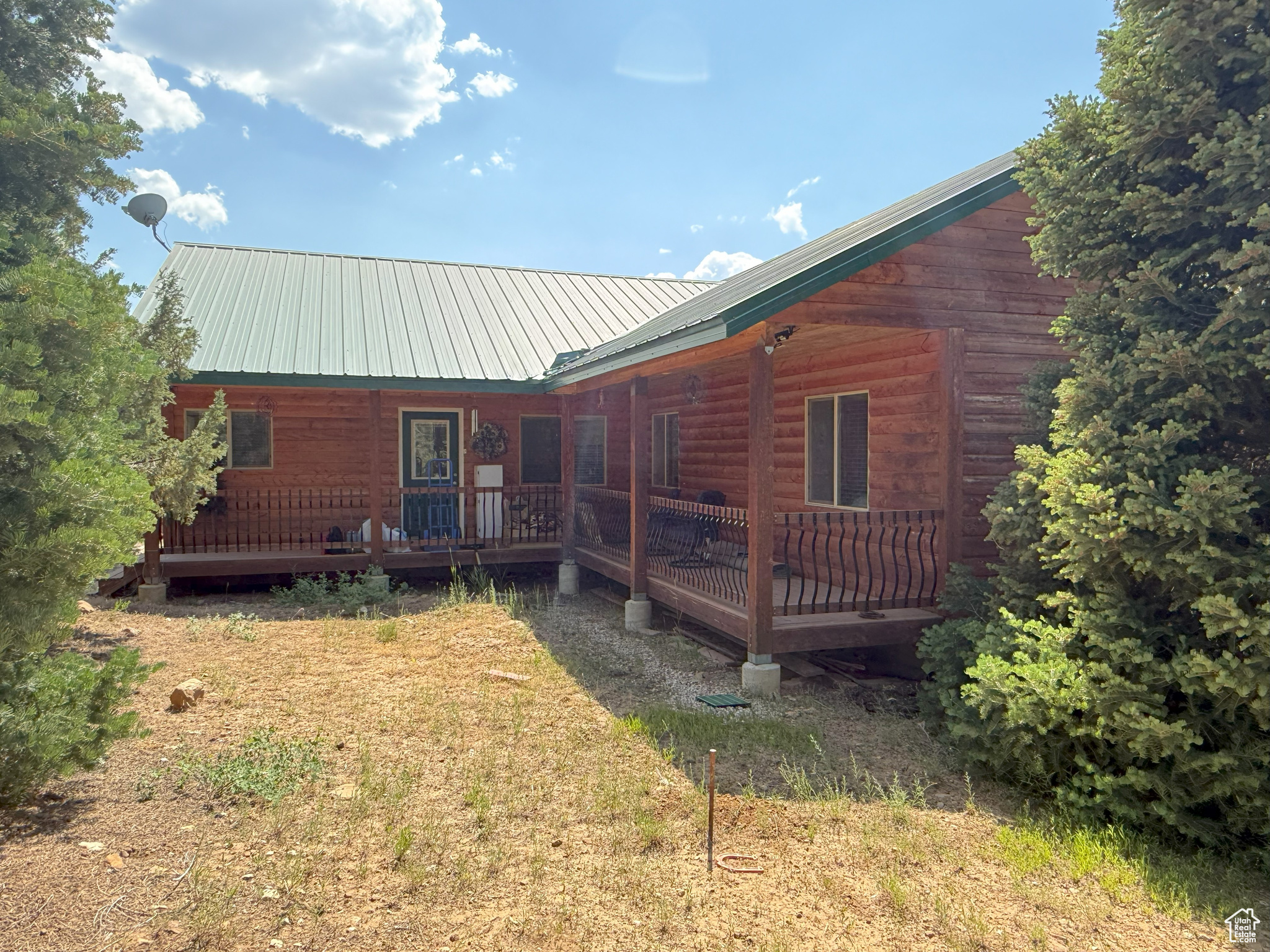 This mountain cabin/home has 3 bedrooms and 2.5 bathrooms on 1.1 acres and includes culinary water via the community water system, electricity from Rocky Mountain Power, and optional internet service. Take in breathtaking views from three spacious decks and the large windows throughout. The great room features vaulted ceilings, oversized windows with amazing views, and a cozy pellet stove. The owner's suite boasts vaulted ceilings and an ensuite bathroom featuring a separate shower, jetted tub, and dual sinks. While it's technically considered a crawl space because of its dirt floor, the crawl space area has an impressive 8-foot ceiling and measures approximately 50 by 13 feet. It also features a beautifully finished woodshop, ideal for projects and hobbies. The property is accessible by car during snow-free months, with winter access via snowmobile or tracked ATV. Conveniently located just over an hour from Provo and only 15 minutes from Mt. Pleasant, where you'll find all the small-town essentials-gas stations, restaurants, grocery and hardware stores, a hospital, and even a nostalgic drive-in theater. Outdoor enthusiasts will appreciate the nearby access to extensive ATV trails, as well as opportunities for fishing, hiking, biking, and hunting. The Pine Creek Ranch POA includes access to a 70-acre common area featuring campsites on the stream, pavilion, sand volleyball court, horse corrals, horseshoe throwing pit, and an area that can accommodate many RVs or trailers. The main parking area is plowed during winter months, although the roads themselves are not. Included in the amenities are water service, trash removal, and upkeep of the private roads and entry gates.  Square footage figures are provided as a courtesy estimate only and were obtained from the county records.  Buyer is advised to obtain an independent measurement.