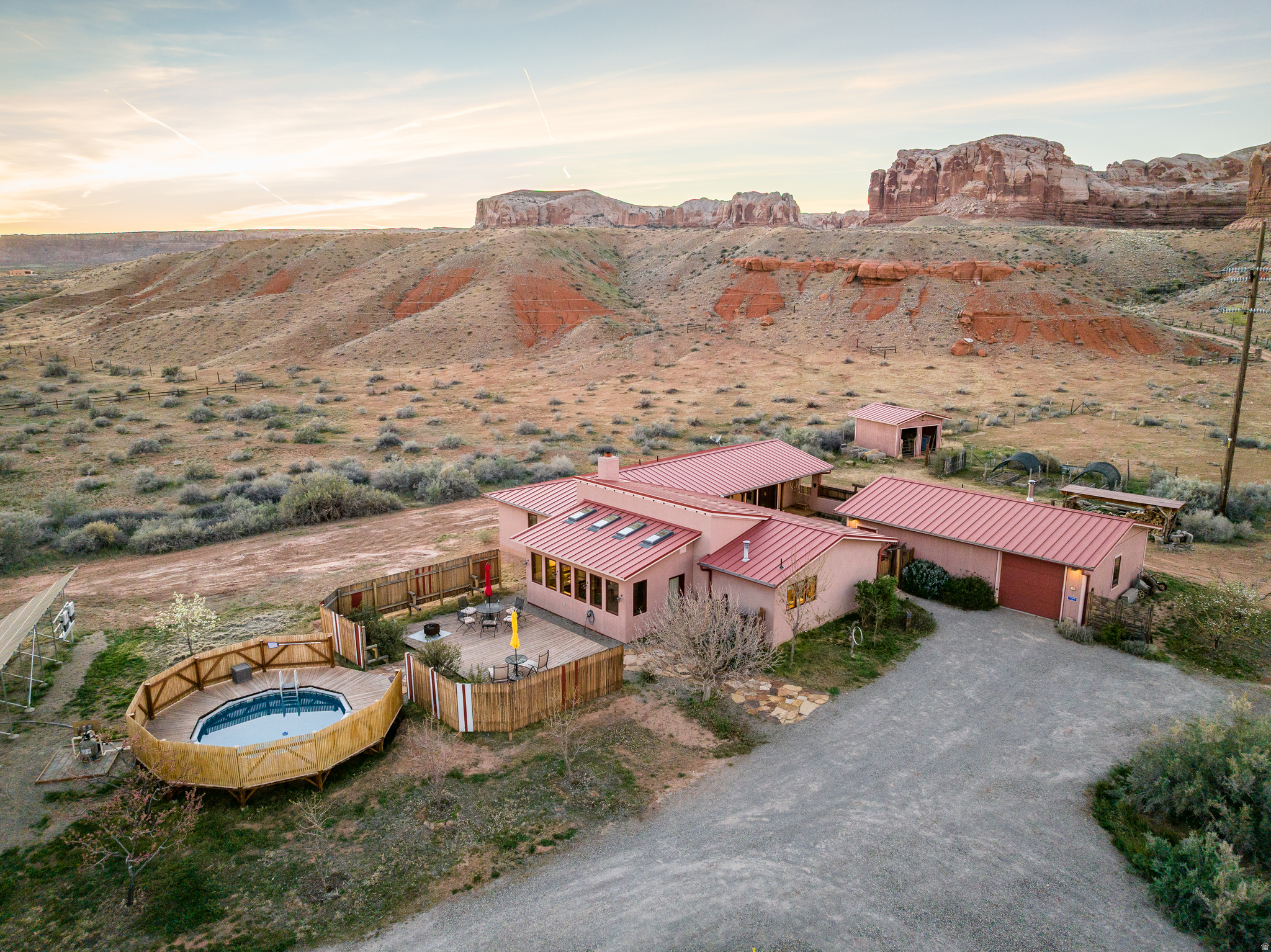 Architect-designed and thoughtfully built by a career general contractor, this beautifully crafted 2-bedroom, 2-bath home sits on 1.3 acres in Bluff, Utah and offers a rare blend of comfort, efficiency, and desert serenity. The open floor plan features a spacious living area with a classic Rumford fireplace, sunroom, generous pantry, and abundant storage including eight closets-one cedar lined. Designed for year-round comfort, the home includes central heat and air conditioning and an energy-efficient solar array that more than offsets electric needs. Quality construction details include Pella windows, an architect-grade metal roof, metal gutters, and a durable stucco exterior. Outdoor spaces are equally inviting, with a private courtyard and fountain, a south-facing deck, and a semi-in-ground pool with surrounding deck-perfect for enjoying Bluff's expansive skies. The property also includes a wired and plumbed workshop with  bath, outdoor shower, one-car garage, small barn and paddock, plus a charming orchard and garden beds filled with honeysuckle, roses, rosemary, and more. Located within a quiet four-home enclave bordered by split-rail fencing, the property offers easy access to the Nature Conservancy lands and the San Juan River.    All information is deemed reliable, but must be confirmed by the Buyer during due diligence.  Square footage figures are provided as a courtesy estimate only and were obtained from Seller. Buyer is advised to obtain an independent measurement.