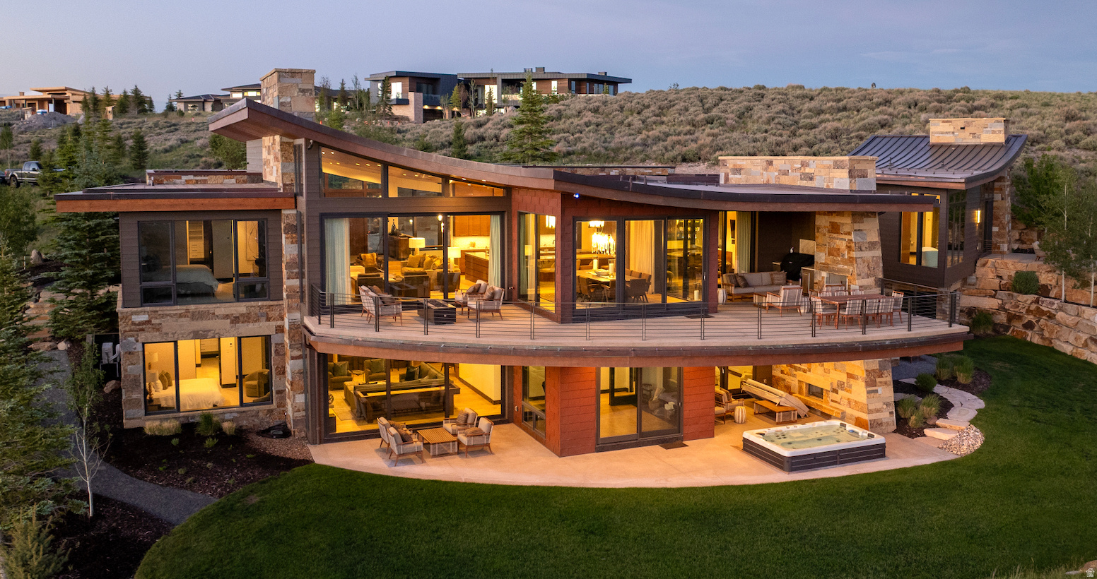 Perched at the very top of Promontory Club, this 9,300-square-foot architectural estate, designed by Michael Upwall and built by Knight Construction, captures panoramic ski-run views from Deer Valley through Utah Olympic Park. Refurnished within the last two years, it is a rare, ready-to-go offering in Park City's premier private mountain community.  Walls of glass and soaring, sculptural ceilings open to the surrounding peaks, while warm stone, wood, and steel create an atmosphere both dramatic and inviting. The main level centers on a double-island kitchen with professional-grade appliances, flowing to elegant living and dining spaces and expansive heated decks and patios for seamless indoor-outdoor living.  Five luxurious ensuite bedrooms offer privacy for family and guests, anchored by a serene primary retreat accessed through an all-glass breezeway, with a spa-inspired bath and walk-through closet. Completing the bedrooms is a custom-designed six-queen bunk room with dual baths, ideal for children and grandchildren. A dedicated office, a 580-bottle wine cellar, glass-walled fitness studio, Swedish sauna, and a ten-person hot tub complete a home built for year-round mountain living. Refined comforts include full Control4 automation for lighting, climate, shades, and audio a home oxygenation system, and a heated driveway and garage.  Set on 2.36 private acres, the residence offers ski and golf just beyond the door, minutes from Park City's Main Street and Deer Valley and roughly 40 minutes from Salt Lake City International Airport. A Full Golf Membership to Promontory is available through separate transaction, unlocking three golf courses, private ski lodges at Deer Valley and Park City Mountain, a new world-class spa, clubhouses and dining, a beach club, equestrian center, a full calendar of member events, and much more.  Offered fully furnished and impeccably appointed, 3364 Scenic Grade is a rare opportunity to own one of Park City's finest mountain estates.