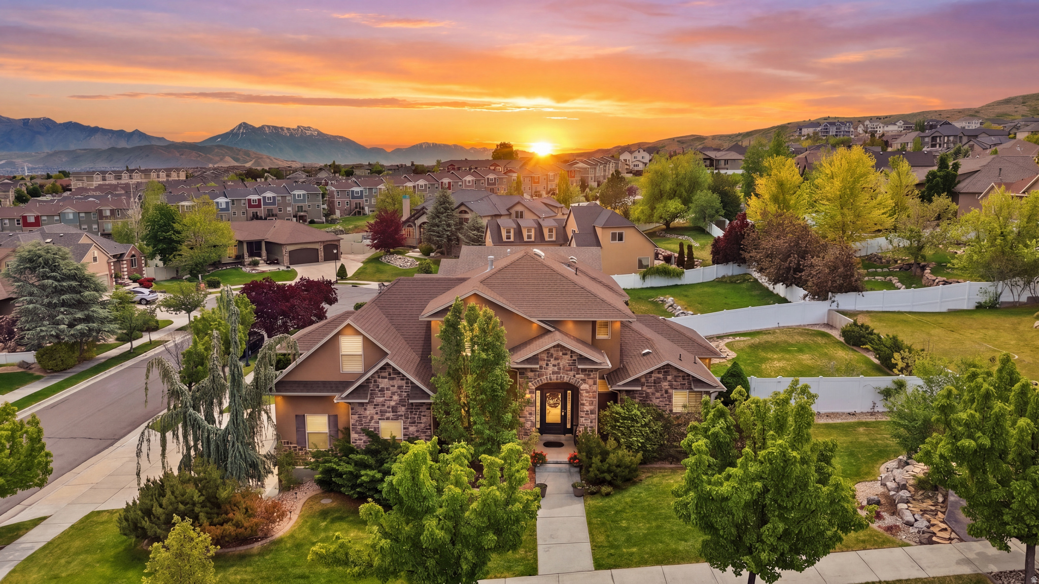 Positioned on a premium .32-acre corner lot in Herriman's highly desirable Rosecrest community, this exceptional home offers the perfect combination of space, functionality, and location. Meticulously maintained and thoughtfully designed, this property checks all the boxes with a spacious floor plan, a fully finished walkout basement with a mother-in-law apartment, RV parking, and a three-car garage. The beautiful stone and stucco exterior is surrounded by mature landscaping and inviting curb appeal. Inside, you'll find an office just off the entry, ideal for working from home, along with spacious gathering areas designed for everyday living and entertaining. The main living room features a cozy natural gas fireplace, large bay windows, and abundant natural light. Plantation shutters throughout the main and upper levels add both elegance and privacy. The kitchen is well-appointed with quartz countertops, stainless steel appliances, a double oven, and ample workspace for preparing meals and hosting guests. The highly desirable main-level primary suite offers convenience and privacy, featuring dual vanities, a jetted tub, and a separate shower. Upstairs, you'll find three additional bedrooms, providing plenty of space for family, guests, or hobbies. The fully finished walkout basement includes a mother-in-law apartment complete with its own kitchen featuring quartz countertops, a spacious family room with a second natural gas fireplace, and an additional bedroom, creating excellent flexibility for multigenerational living, guests, or potential rental income. Step outside and enjoy an incredible backyard designed for entertaining and making memories. The newer deck extends from the main living area and kitchen, offering seamless indoor-outdoor living. The expansive yard features mature trees, a built-in pergola perfect for relaxing in a hammock, a fire pit area, and plenty of room for gatherings, recreation, and play. Located just minutes from Blackridge Reservoir, Blackridge Trail, Emmeline Park, Mountain View Corridor, and the rapidly growing Mountain View Village with its restaurants, shopping, entertainment, and movie theater, this home offers the lifestyle today's buyers are searching for. Combining a prime location, flexible floor plan, exceptional outdoor living spaces, and pride of ownership throughout, this is a rare opportunity in one of Herriman's most sought-after communities. Schedule your private showing today. **TO VIEW FULL MOTION VIDEO OF THIS HOME PRESS THE TOUR BUTTON***THIS HOME IS FEATURED ON TELEVISIONS REAL ESTATE ESSENTIALS ABC4 UTAH SUNDAYS AT 4:30PM *** Square footage figures are provided as a courtesy estimate only. Buyer is advised to obtain an independent measurement & verify all info.