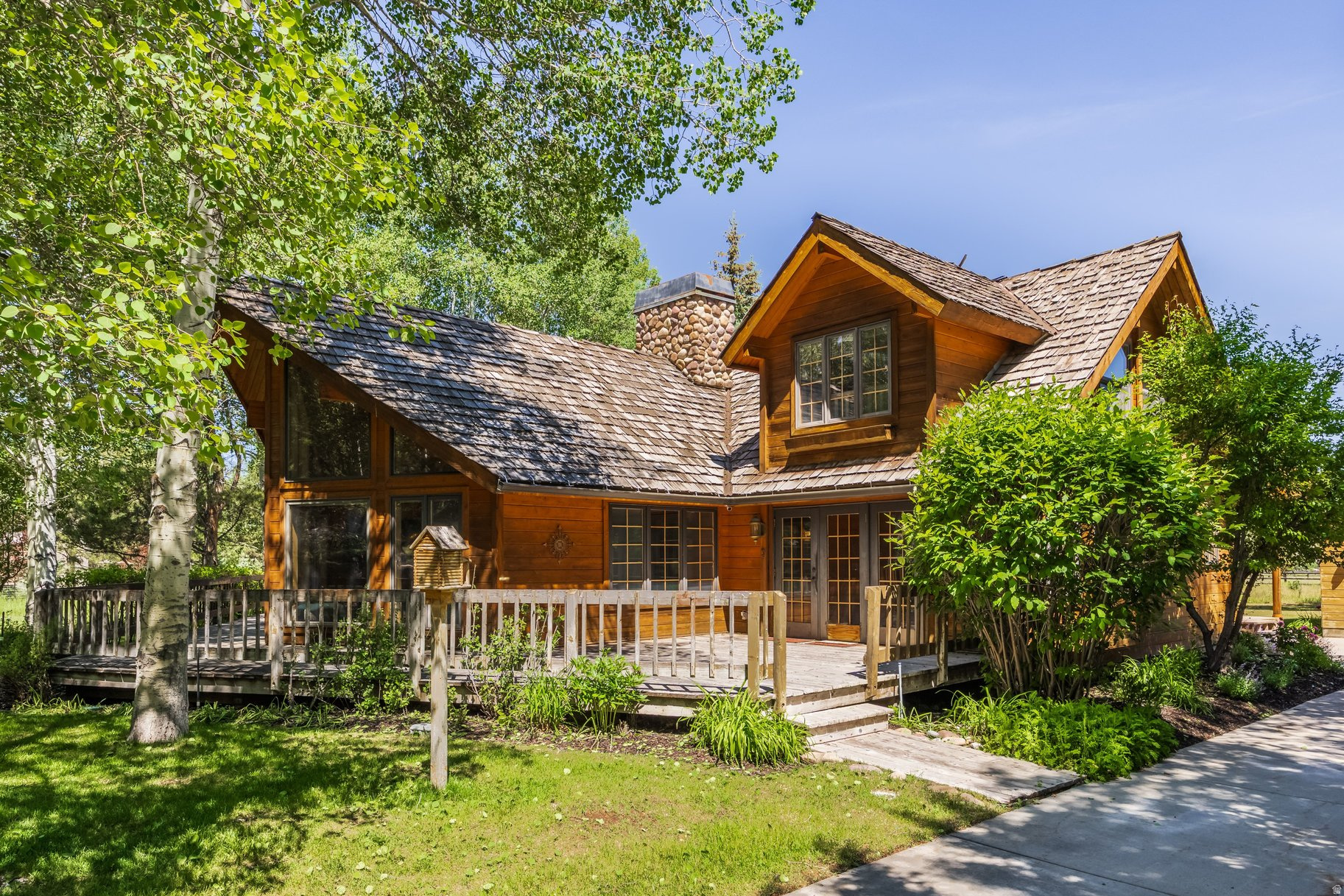 Looking for a mountain home on a private one-acre lot with direct trail access just minutes from Historic Main Street and Park City's world-class resorts? This meticulously maintained 4-bedroom home in Holiday Ranchettes offers timeless craftsmanship, exceptional privacy, and the rare opportunity to create your dream home in one of Park City's most coveted neighborhoods. Located on a quiet, tree-lined cul-de-sac in the highly desirable Holiday Ranchettes subdivision of Park Meadows, 1226 Moray Court is a rare offering on a full one-acre homesite. Built by International Homes of Cedar and meticulously maintained, this 3,210 square foot residence combines quality craftsmanship with an unbeatable location. The inviting floor plan features soaring ceilings, a spacious kitchen with newer appliances, and a dramatic two-story stone fireplace that anchors the great room. With four bedrooms, two full bathrooms, and two half bathrooms, the home offers comfortable living for family and guests, while the upgraded radiant heating system provides year-round comfort. A detached heated garage with a workbench offers abundant space for vehicles, recreational equipment, and all your mountain gear. Step outside to immediate access to Park City's renowned trail system from the neighborhood bridle trails, with hiking, biking, and outdoor recreation right from your doorstep. Just minutes from Historic Main Street, Deer Valley Resort, and Park City Mountain Resort, this property delivers both convenience and tranquility. Lovingly cared for over the years, the home is ready for its next chapter and presents an exceptional opportunity for a new owner to personalize and update the interiors to their own style. The offering price reflects the rare chance to own a full one-acre property in one of Park City's most sought-after neighborhoods, where opportunities like this are increasingly difficult to find.