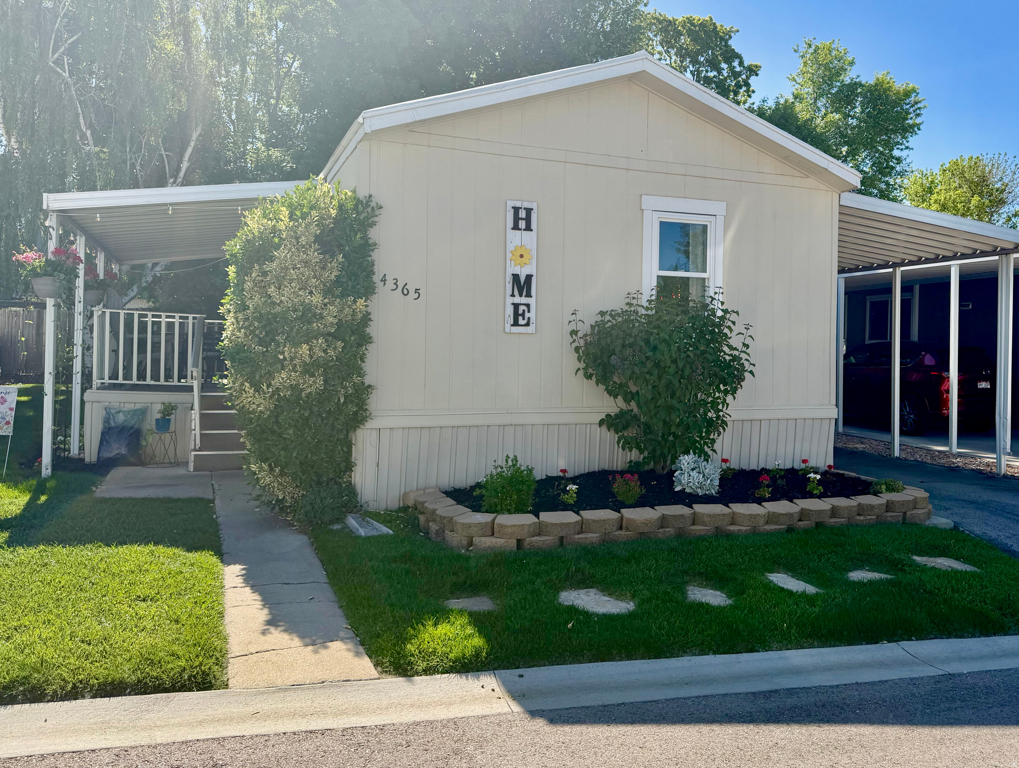 Nestled among shade trees in the beautifully maintained gated 55+ community of Cottonwood Coves, this cozy and inviting home offers comfort, charm, and peaceful community living. Enjoy quiet tree-lined streets, the soothing sounds of Big Cottonwood Creek winding through the grounds, and wonderful neighborhood amenities including a clubhouse and seasonal swimming pool. Inside the home, you'll find a spacious open-concept living and kitchen area with vaulted ceilings that create an airy "great room" feel perfect for relaxing or entertaining. The home features 2 bedrooms and 2 full bathrooms, plus a covered porch/deck ideal for enjoying cool mornings and shaded evenings beneath the mature trees. Outside, there's also a covered carport, two storage sheds, and a private backyard retreat. This well-cared-for home offers a wonderful opportunity to add your own updates and personal touches while enjoying one of the area's most peaceful and welcoming communities. All appliances are included, including refrigerator, dishwasher, washer, and dryer. Pets are permitted. Buyer must be approved by property management prior to ownership. Please apply at the community office.