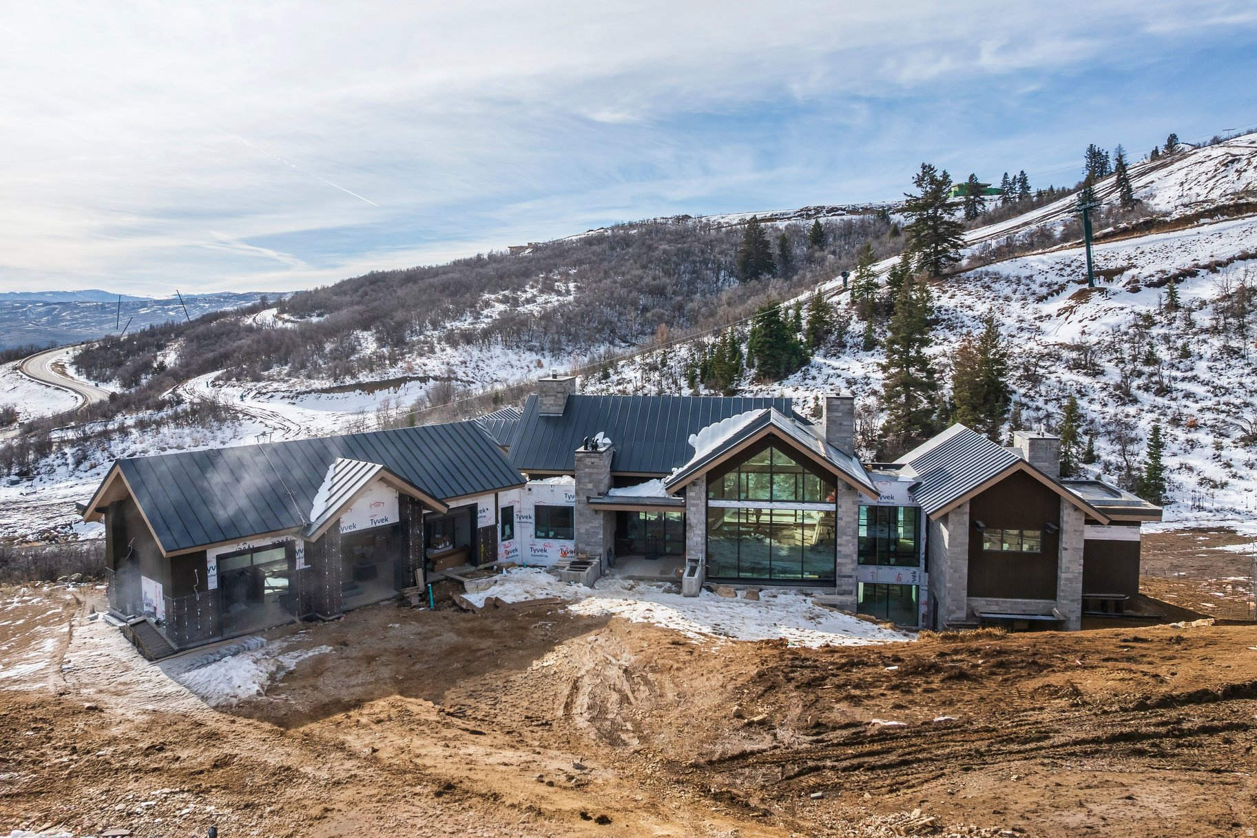 Welcome to 10098 N Himmel Court, a stunning new construction residence in the exclusive Velvaere ski community at Deer Valley East Village-Park City's newest hub for world-class skiing, dining, and year-round recreation. Situated on a rare ski-in/ski-out 0.92-acre parcel at the end of a quiet cul-de-sac, this 8,031 sq ft mountain retreat offers the ultimate in luxury, convenience, and design.  Thoughtfully designed by The Curtis Group, expertly built by H2 Homes, and elegantly styled by Olsen Home Design, every detail of this home reflects quality and craftsmanship. The open-concept floor plan features two spacious bedroom suites on the main level and four additional bedrooms on the lower level, including a dedicated bunk room-all with private en-suite bathrooms, perfect for hosting family and guests.  An expansive layout flows effortlessly into outdoor living spaces, including a generous back deck and a covered patio with a hot tub-ideal for soaking in the surrounding alpine beauty. Enjoy stunning views of the Jordanelle Reservoir while entertaining or unwinding after a day on the slopes.  The lower level is designed for fun and relaxation with a large rec room and wet bar, a home theater, a fitness area, and a dedicated ski room with built-in storage-perfect for aprs-ski gatherings. With direct ski access and a premier location in Deer Valley's newest village, this rare offering blends elevated mountain living with unparalleled access to Utah's most exciting resort destination.