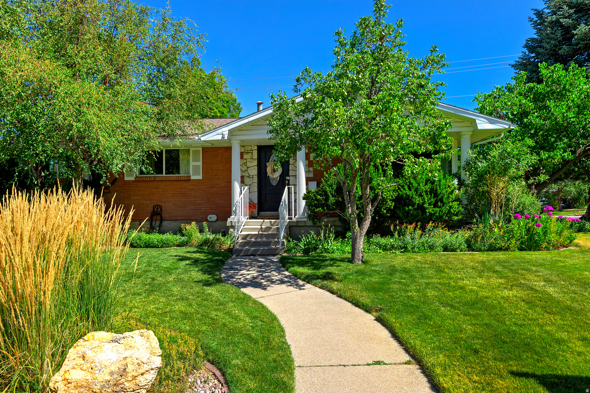 This charming brick rambler sits on a corner lot in a quiet Cottonwood Heights neighborhood with beautiful mountain views. Spanning over 3,600 square feet, the home features 4 total bedrooms, including a primary bedroom with an attached bathroom, plus a dedicated office. Inside, the spacious floor plan feels open and inviting with tasteful updates throughout. It includes a formal living room and a family room off the kitchen that opens to a bright attached sunroom. Outside, you'll enjoy the mature landscaping, fully fenced yard, and a 2-car attached garage. A comfortable, well-loved home in a fantastic location.