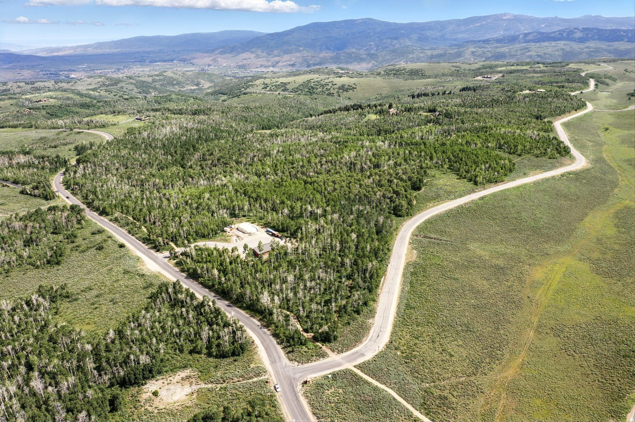 Rare 160-Acre Aspen-Covered Corner Lot with Timpanogos Views  Wolf Creek Ranch Centrally located in the subdivision Lot 11 is a stunning 160-acre corner parcel in the heart of Wolf Creek Ranch, adjacent to the legacy estate on Lot 12 (MLS 2094375). This exceptional property offers the perfect blend of seclusion, natural beauty, and year-round access to everything that makes mountain living extraordinary. Fully wooded with towering Aspen groves, this lot captures panoramic western ridgeline views, including the iconic Mt Timpanogos-a backdrop that changes beautifully with the seasons. With multiple building envelope options available (subject to HOA approval), you can position your dream home to maximize privacy, sunlight, and views-whether coming off Forest Creek Road or Wolf Creek Ranch Rd. As an owner in Wolf Creek Ranch, you'll enjoy access to: -60 miles of private trails for hiking, biking, horseback riding, and winter sports and ATVs - 1.5 miles of private Provo River frontage for blue-ribbon fly fishing - Three fully stocked fishing ponds and community yurts - Direct access to Uinta National Forest. - A private equestrian facility and guest lodging for owner use - Gated security and concierge services Just 25 minutes from Park City and the new Deer Valley East Village, as well as Heber City, the Heber Valley Airport. Approximately an hour to Salt Lake International Airport-this is the ideal location for a private mountain getaway with world-class amenities at your fingertips. Whether purchased on its own or combined with the adjacent estate on Lot 12, Lot 11 offers a once-in-a-lifetime opportunity to build your legacy in one of Utah's most exclusive and awe-inspiring communities.