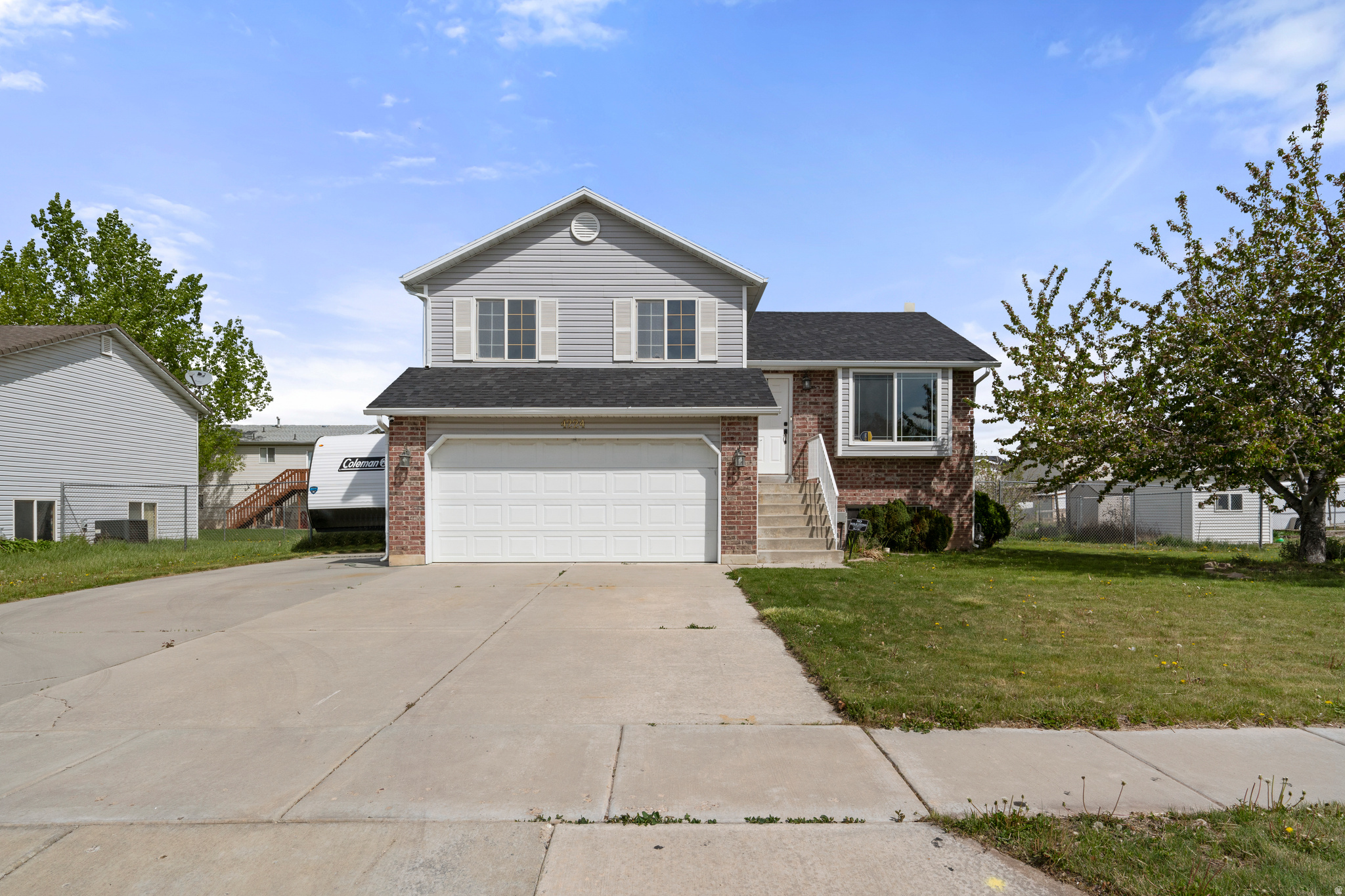 Welcome to this well-maintained split-level home in a quiet neighborhood. The main level features an open living, dining, and kitchen area with good natural light, stainless steel appliances, and plenty of cabinet storage. Upstairs there are three bedrooms and two full bathrooms, the primary having its own en suite. The basement offers an additional living space that works well for a family room, den, office, or play area. Large, fully fenced backyard with a covered patio and two storage sheds. Extended driveway with RV Parking and 2-car garage. New roof - estimated 5yrs old.
